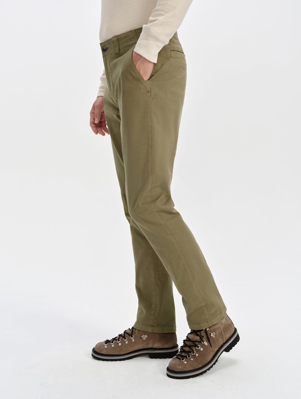 Side profile lower-body view of man wearing the Flint Chino Pant in Cadet from AETHER Apparel.
