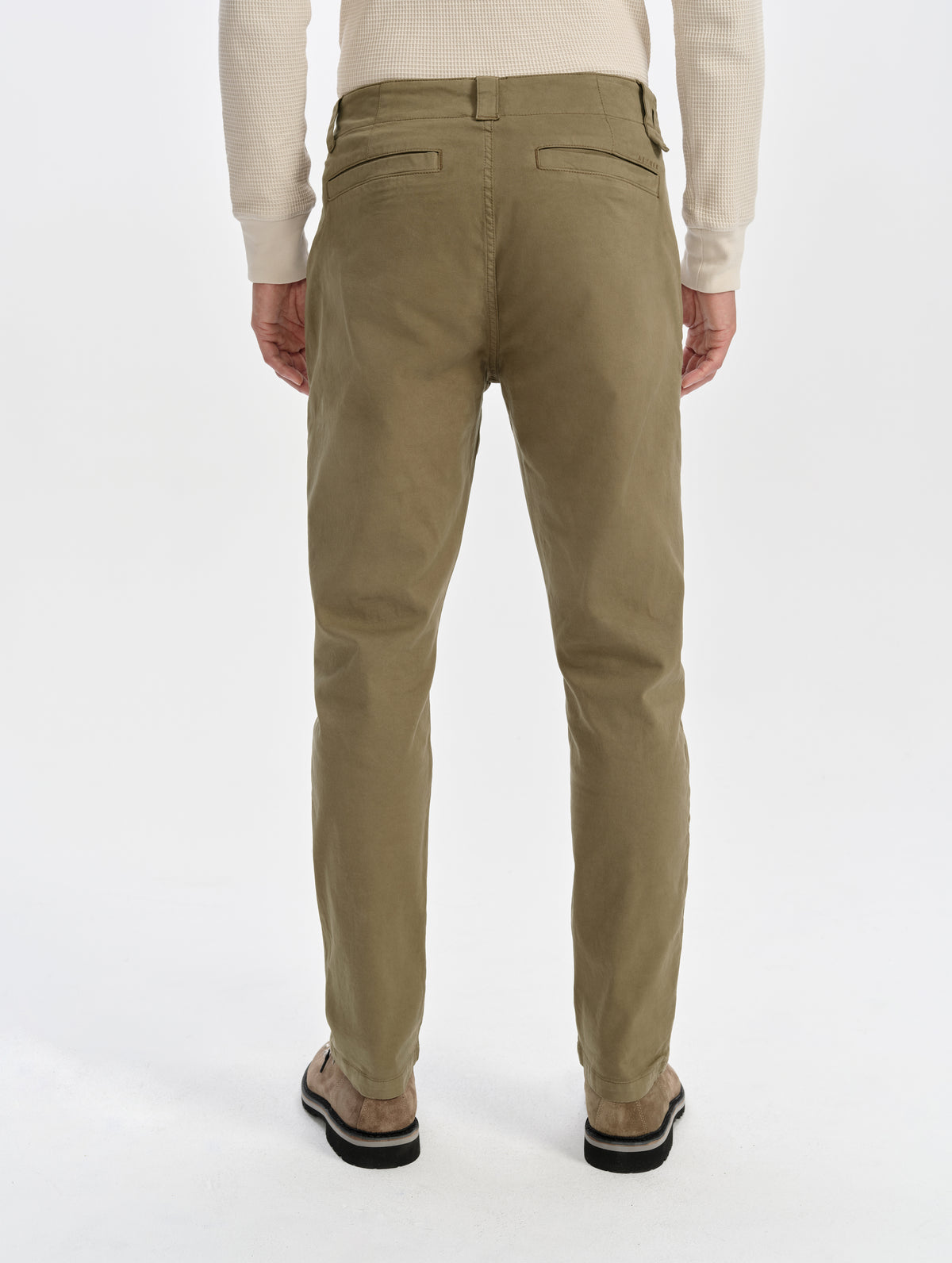 Rear lower-body view of man wearing the Flint Chino Pant in Cadet from AETHER Apparel.
