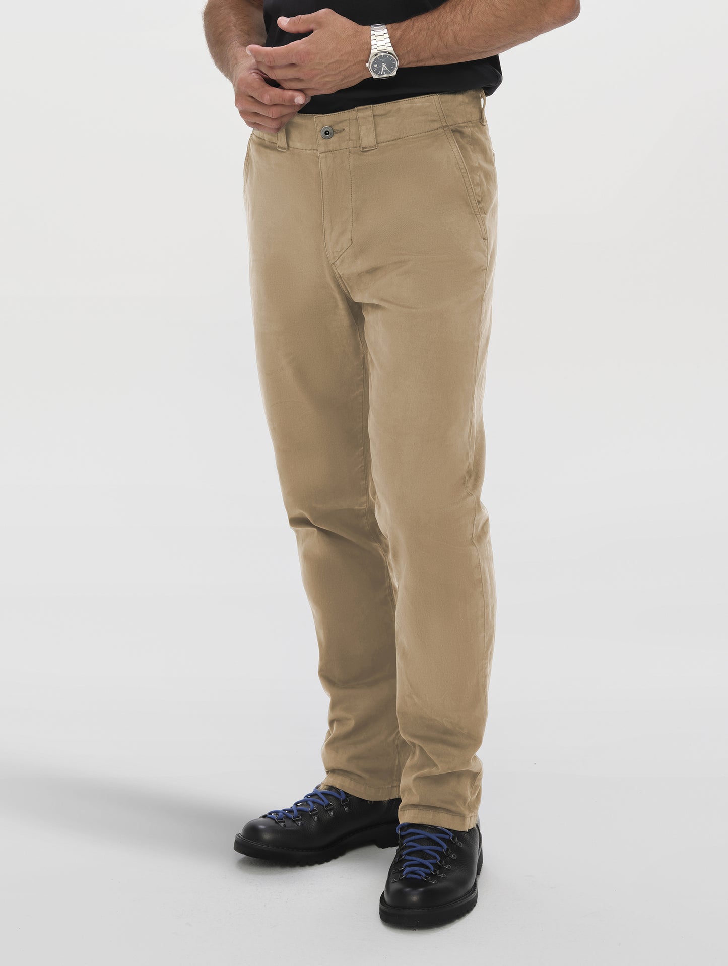 Front angled lower-body view of man wearing the Flint Chino Pant in Desert Tan from AETHER Apparel.