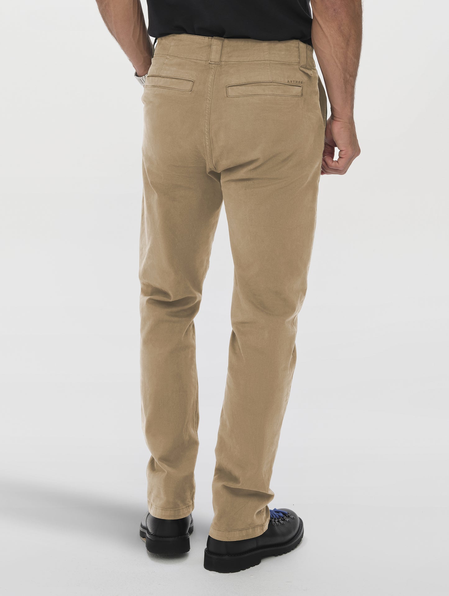Rear lower-body view of man wearing the Flint Chino Pant in Desert Tan from AETHER Apparel.