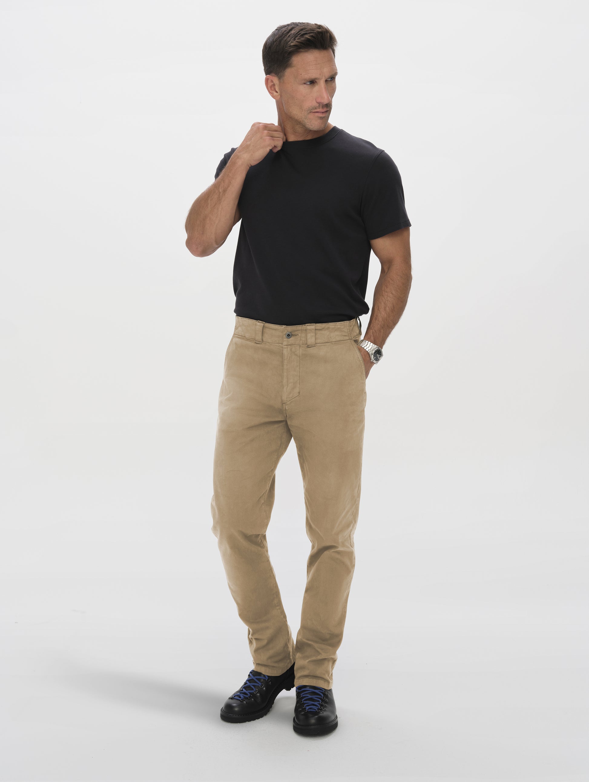 Front full-body view of man wearing the Flint Chino Pant in Desert Tan from AETHER Apparel.