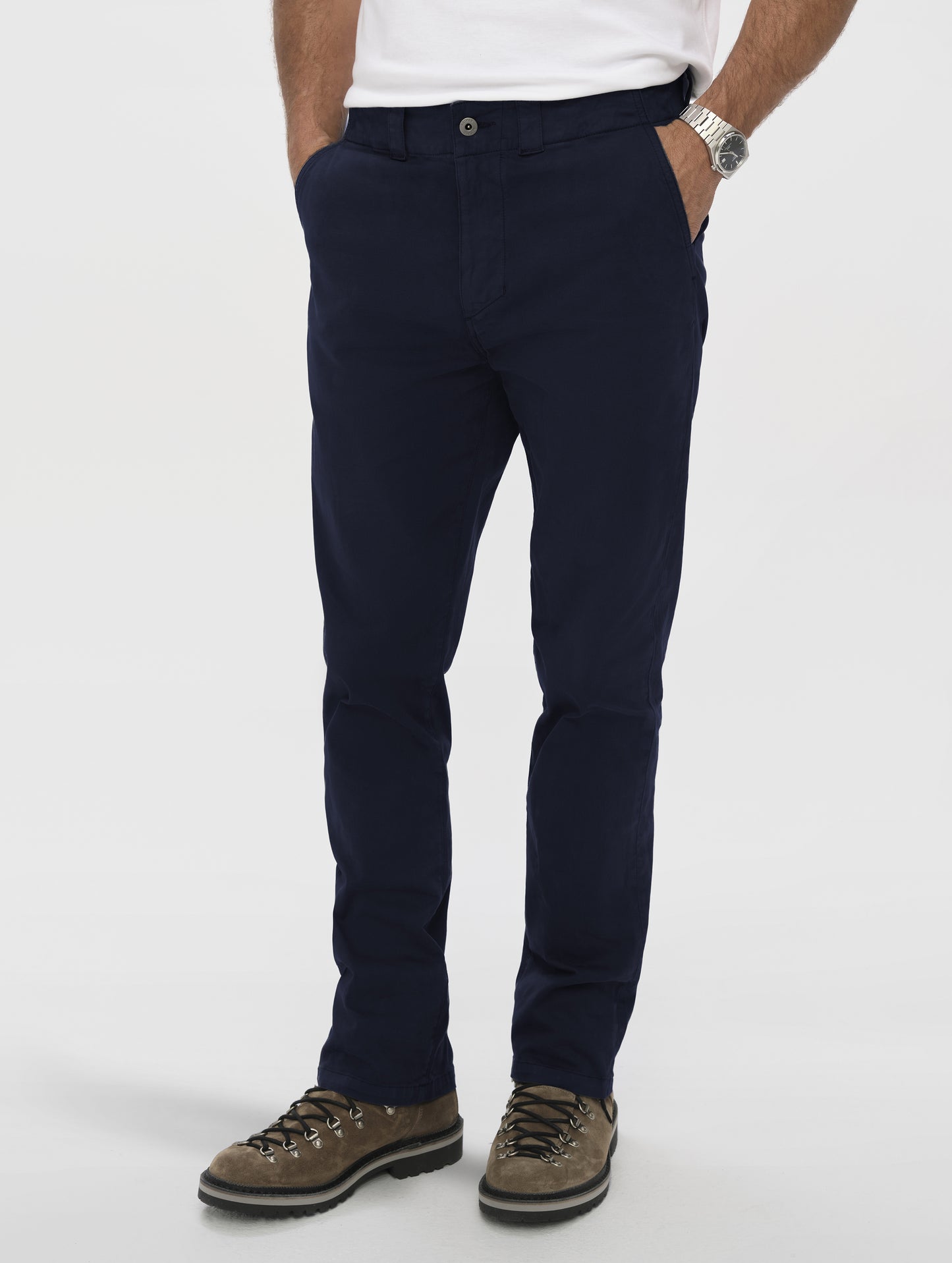 Front angled lower-body view of man wearing the Flint Chino Pant in Total Eclipse dark blue from AETHER Apparel.