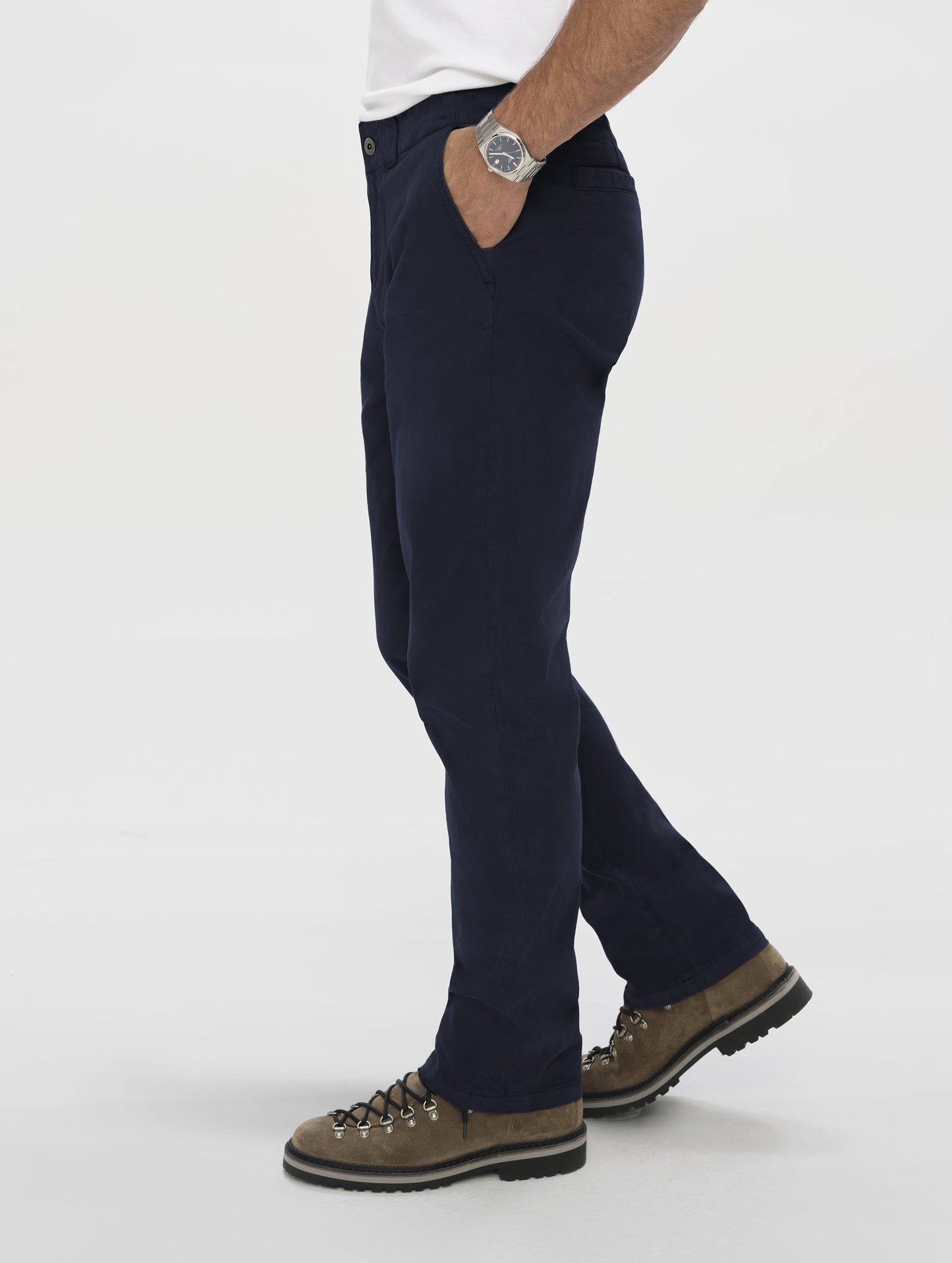 Side profile lower-body view of man wearing the Flint Chino Pant in Total Eclipse dark blue from AETHER Apparel.