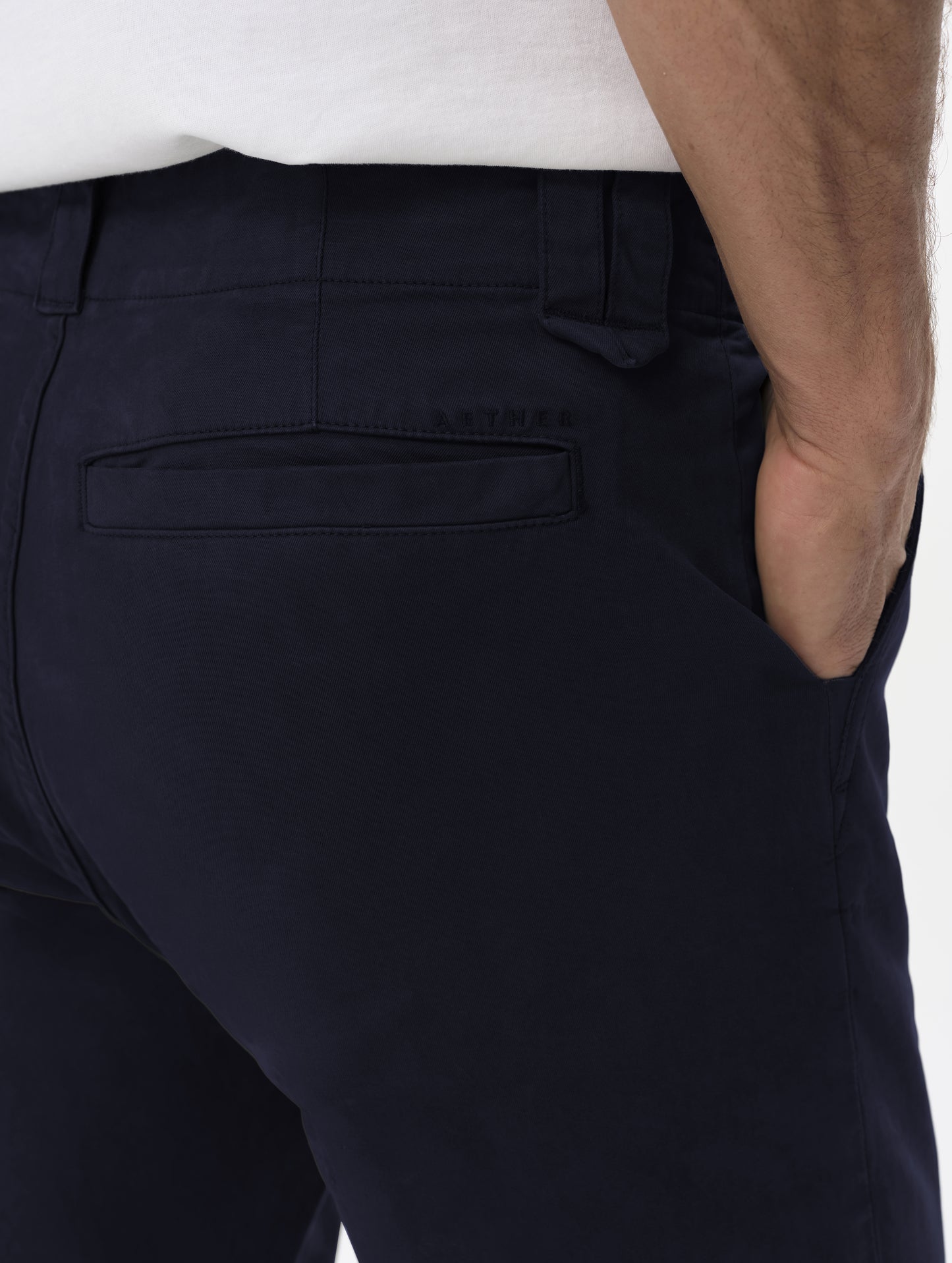 Closeup detailed view of the back pockets and hand pockets on the Flint Chino Pant in Total Eclipse dark blue from AETHER Apparel.