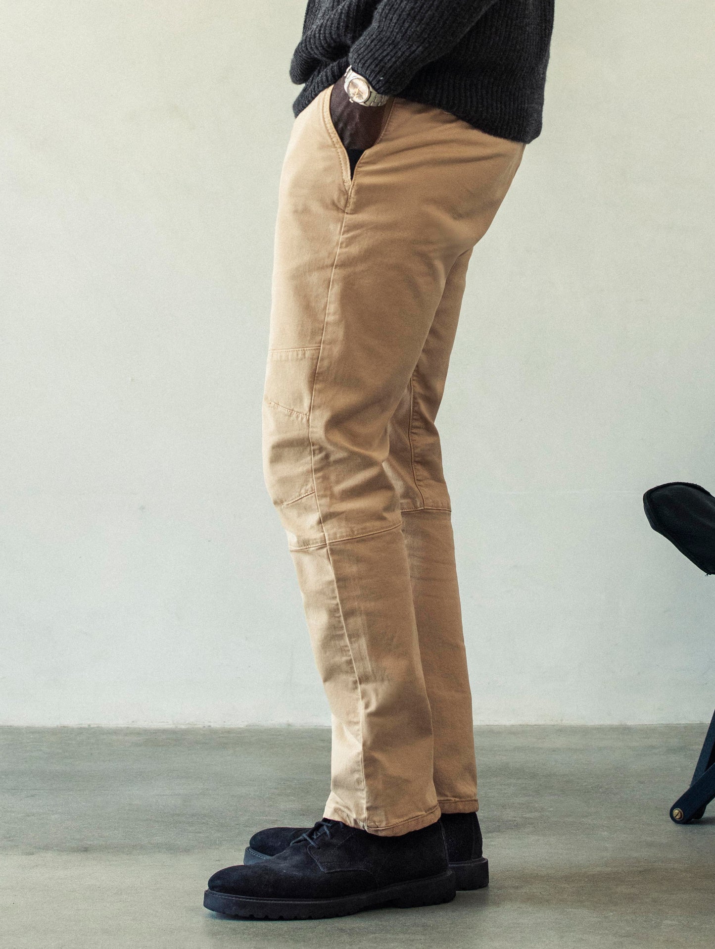 Left side profile lower body view of man wearing Gabriel Articulated Chino Stretch pant in Desert Tan from AETHER Apparel.