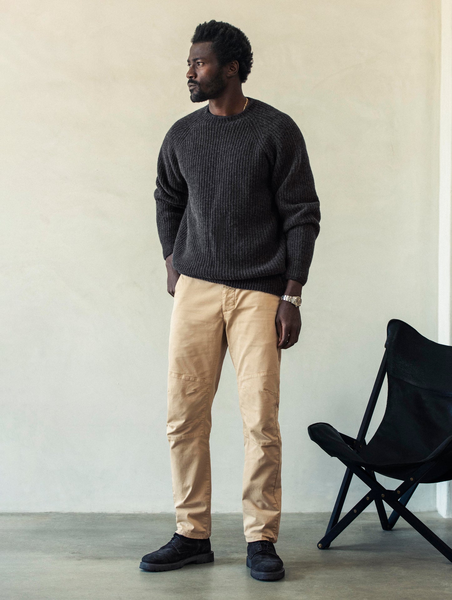 Front angled full-body view of man wearing Gabriel Articulated Chino Stretch pant in Desert Tan from AETHER Apparel.