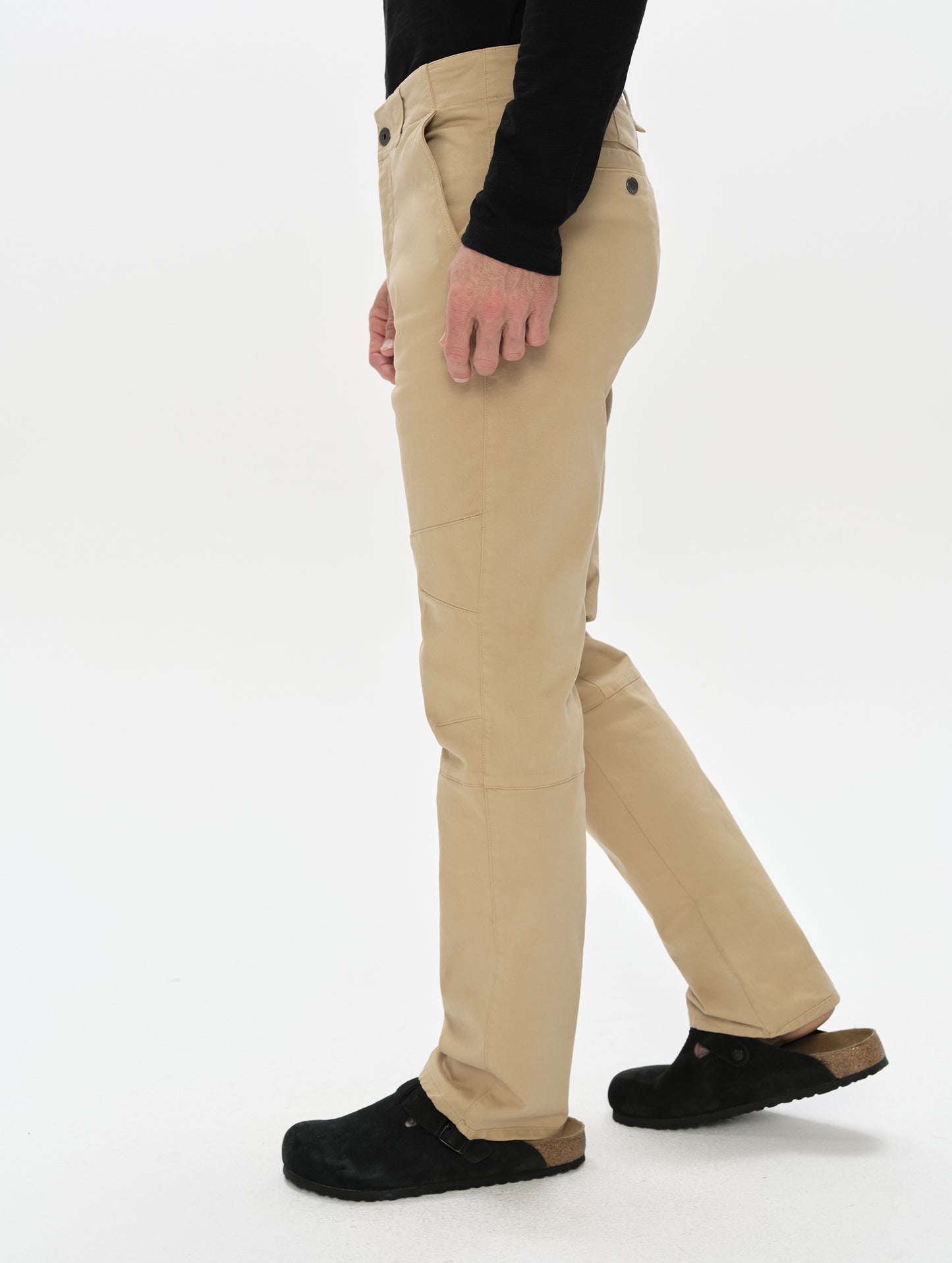Side profile, lower-body view of man wearing the Gabriel Articulated Chino in Desert Tan from AETHER Apparel.