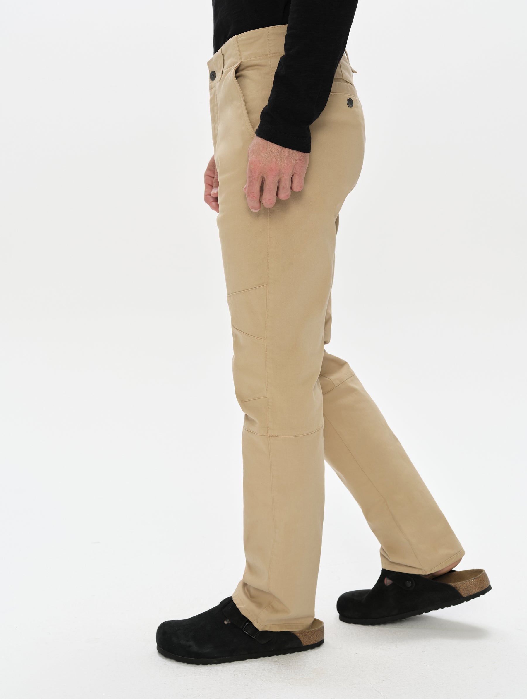 Side profile, lower-body view of man wearing the Gabriel Articulated Chino in Desert Tan from AETHER Apparel.