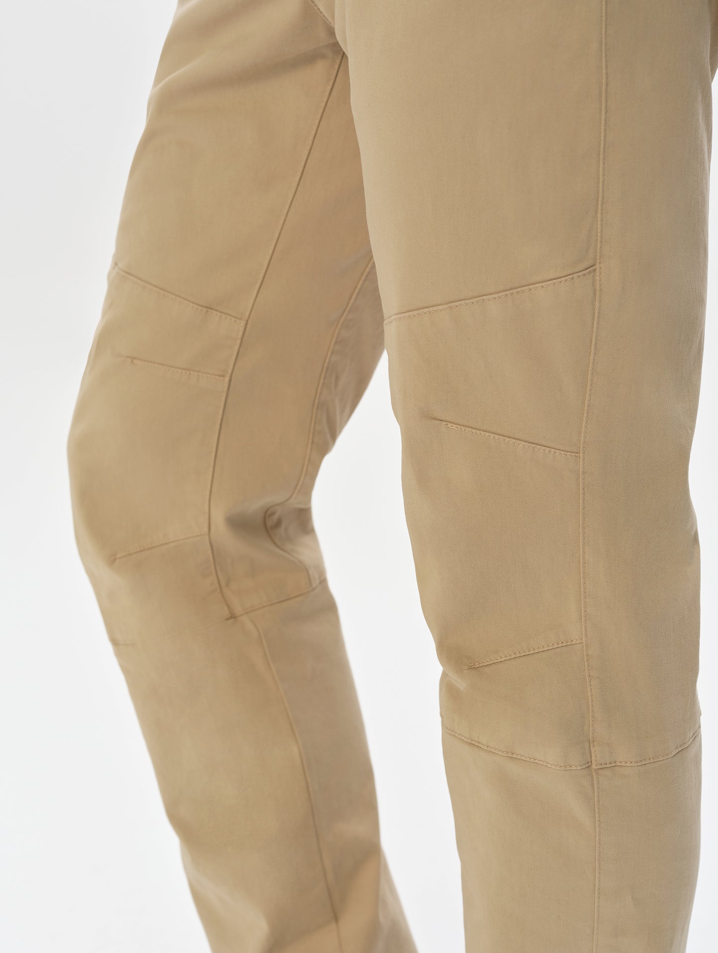 Closeup detailed view of the mobility-bolstering articulated knee darts on the Gabriel Articulated Chino in Desert Tan from AETHER Apparel.