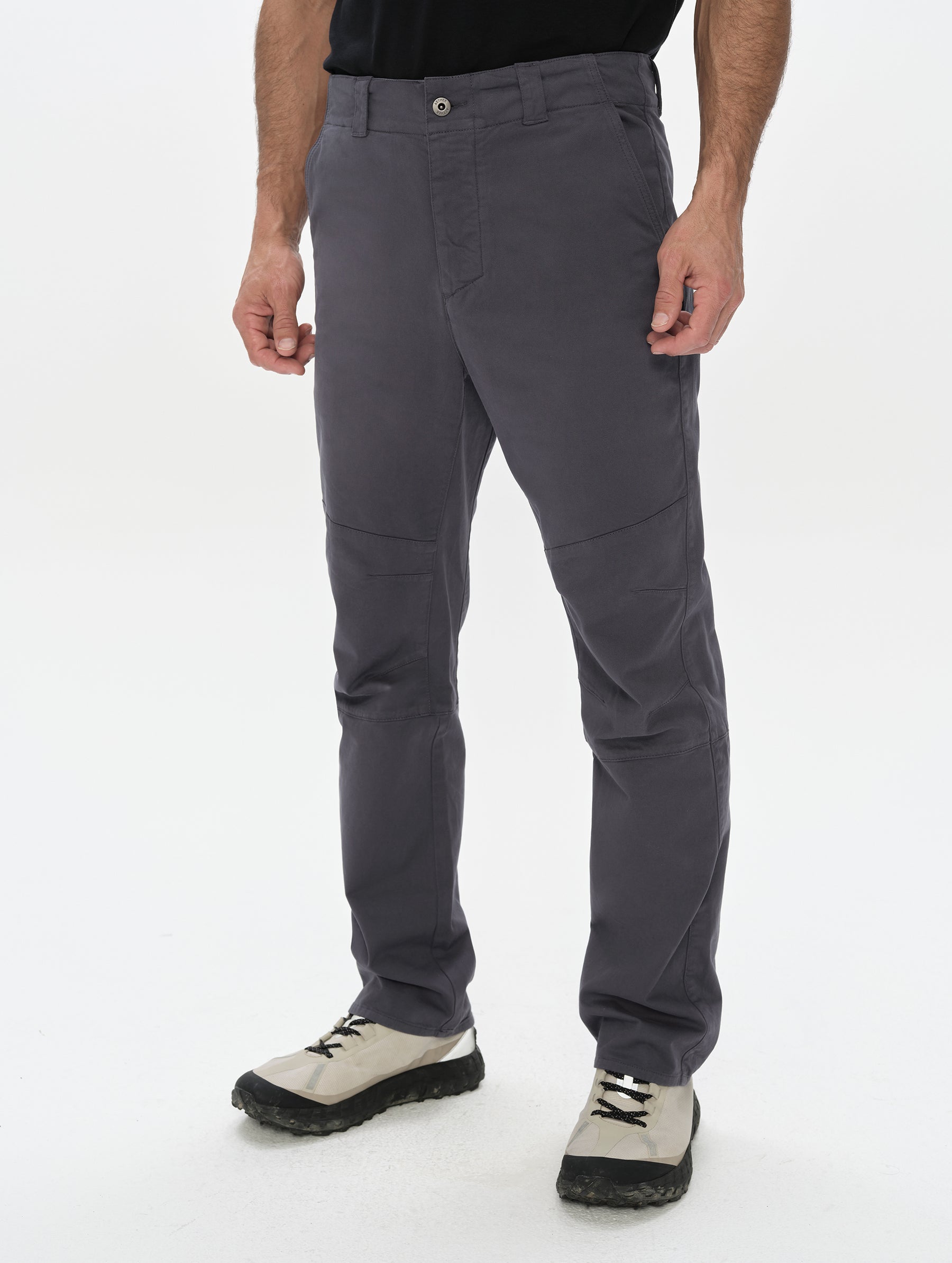 Front, 3/4, lower-body view of man wearing the Gabriel Articulated Chino in Graphite from AETHER Apparel.