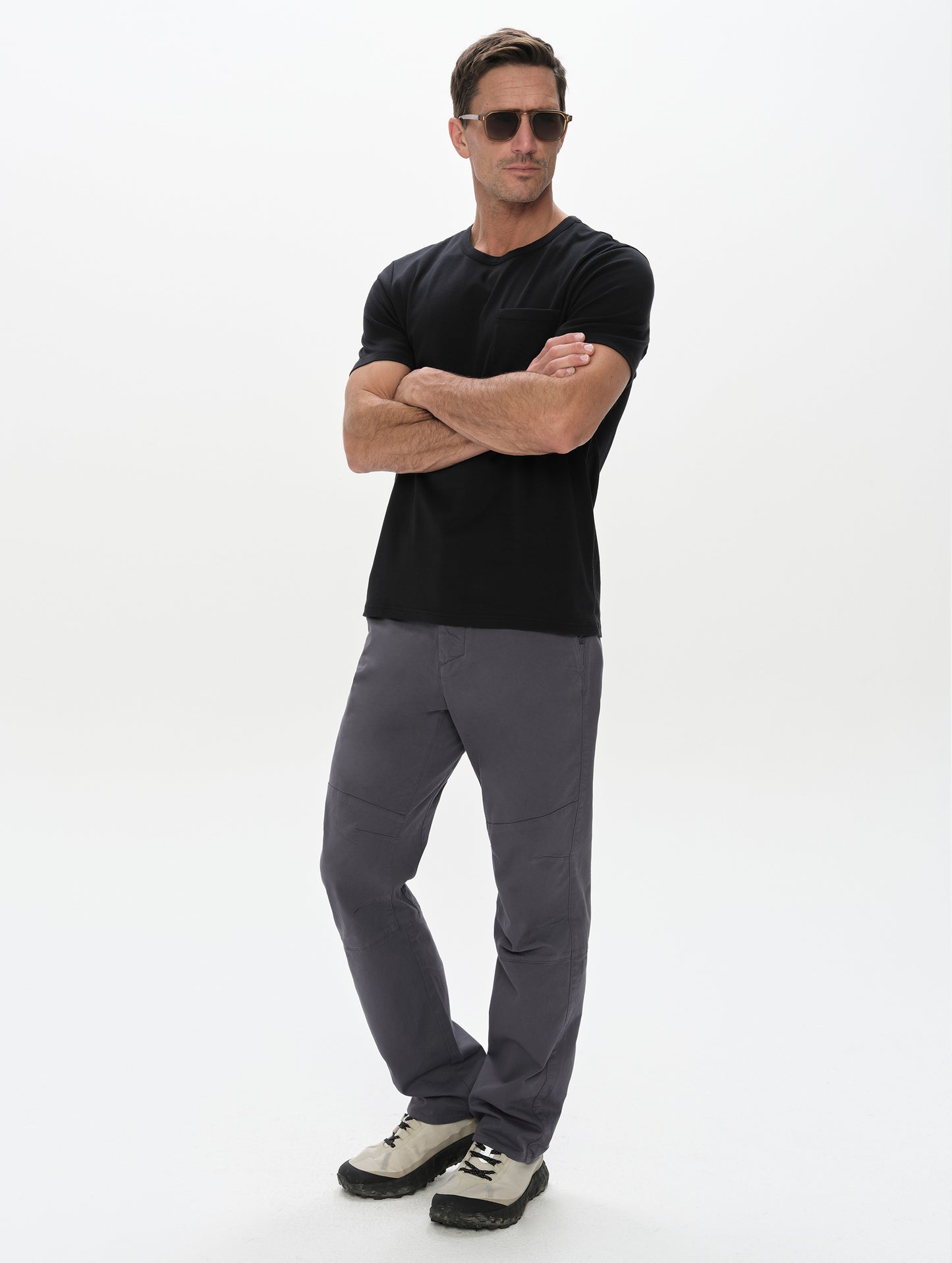 Front, full-body view of man wearing the Gabriel Articulated Chino in Graphite from AETHER Apparel.