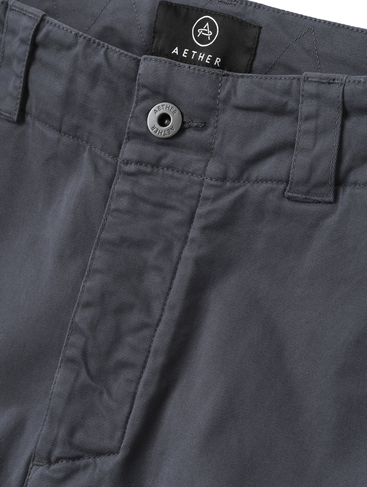 Closeup detailed view of the center-front closure on the Gabriel Articulated Chino in Graphite from AETHER Apparel.