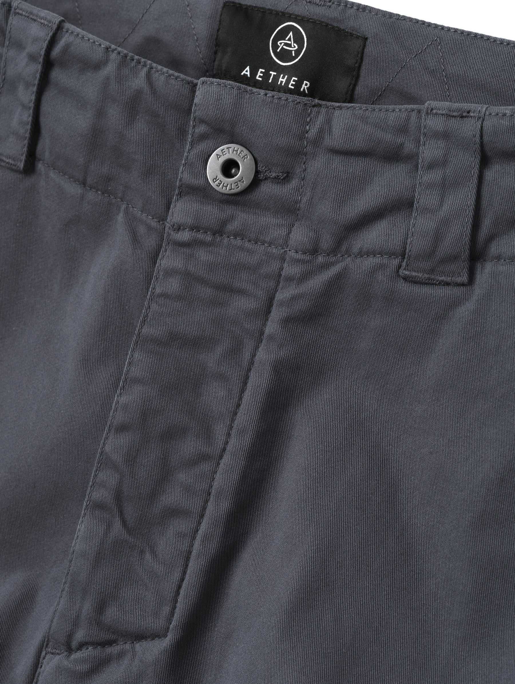 Closeup detailed view of the center-front closure on the Gabriel Articulated Chino in Graphite from AETHER Apparel.