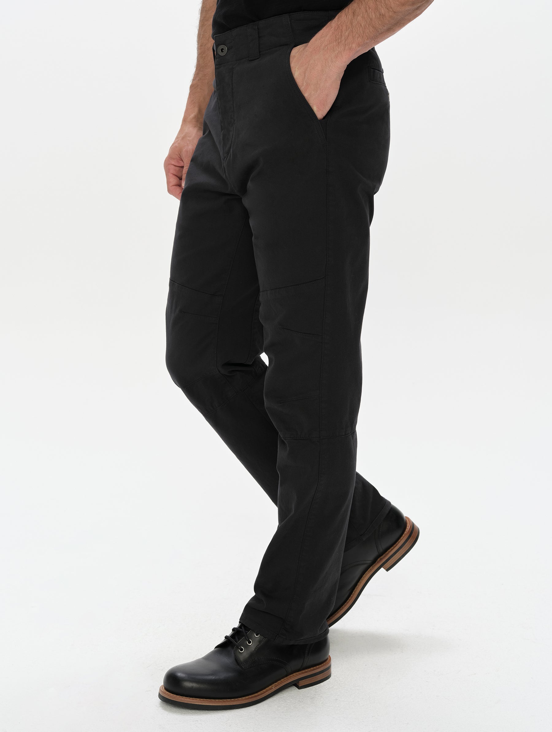 Front, 3/4, lower-body view of man wearing the Gabriel Articulated Chino in Onyx Black from AETHER Apparel.