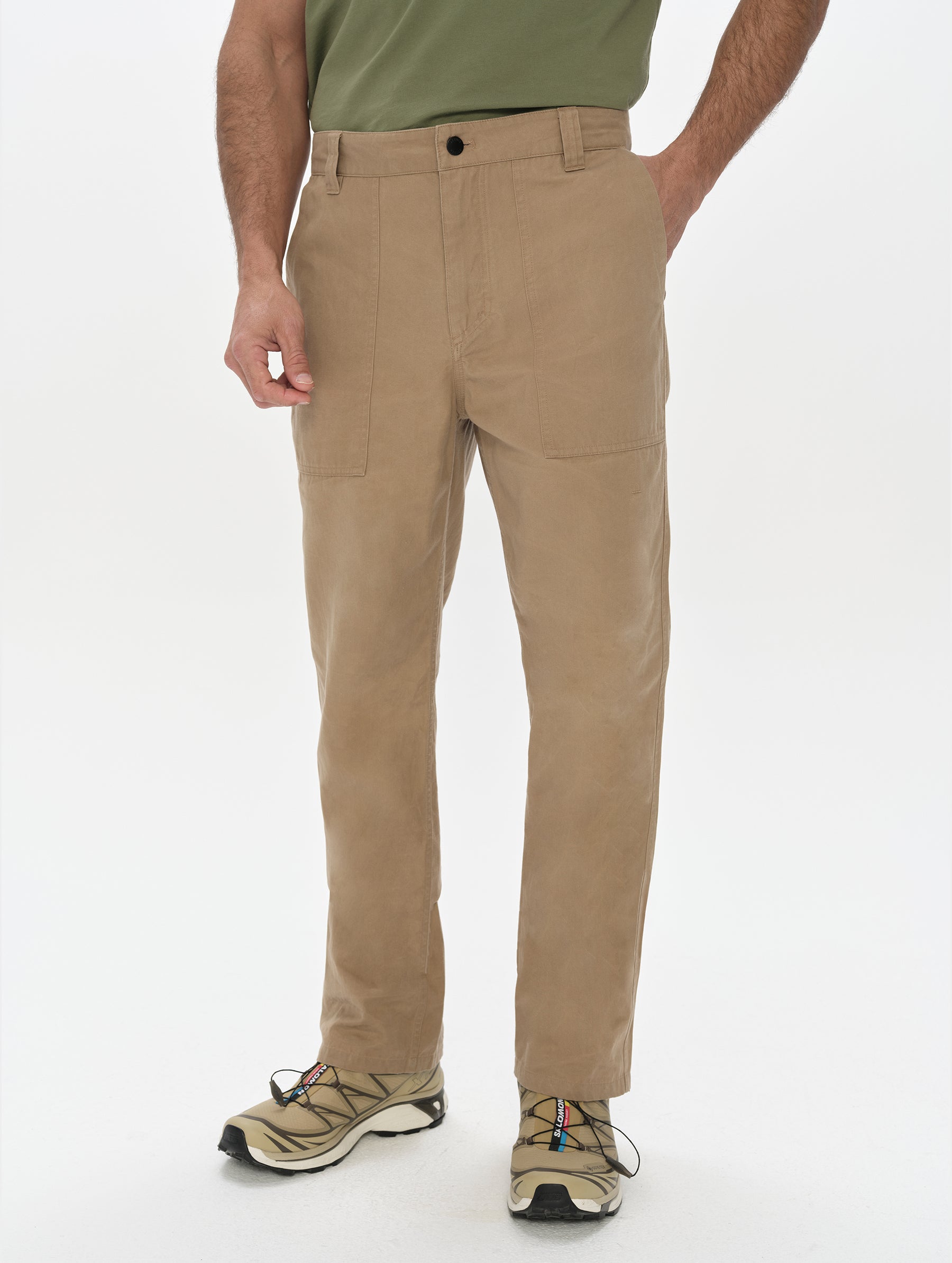 Front, lower-body view of man wearing the Gage Cotton Pant in Desert Tan from AETHER Apparel.