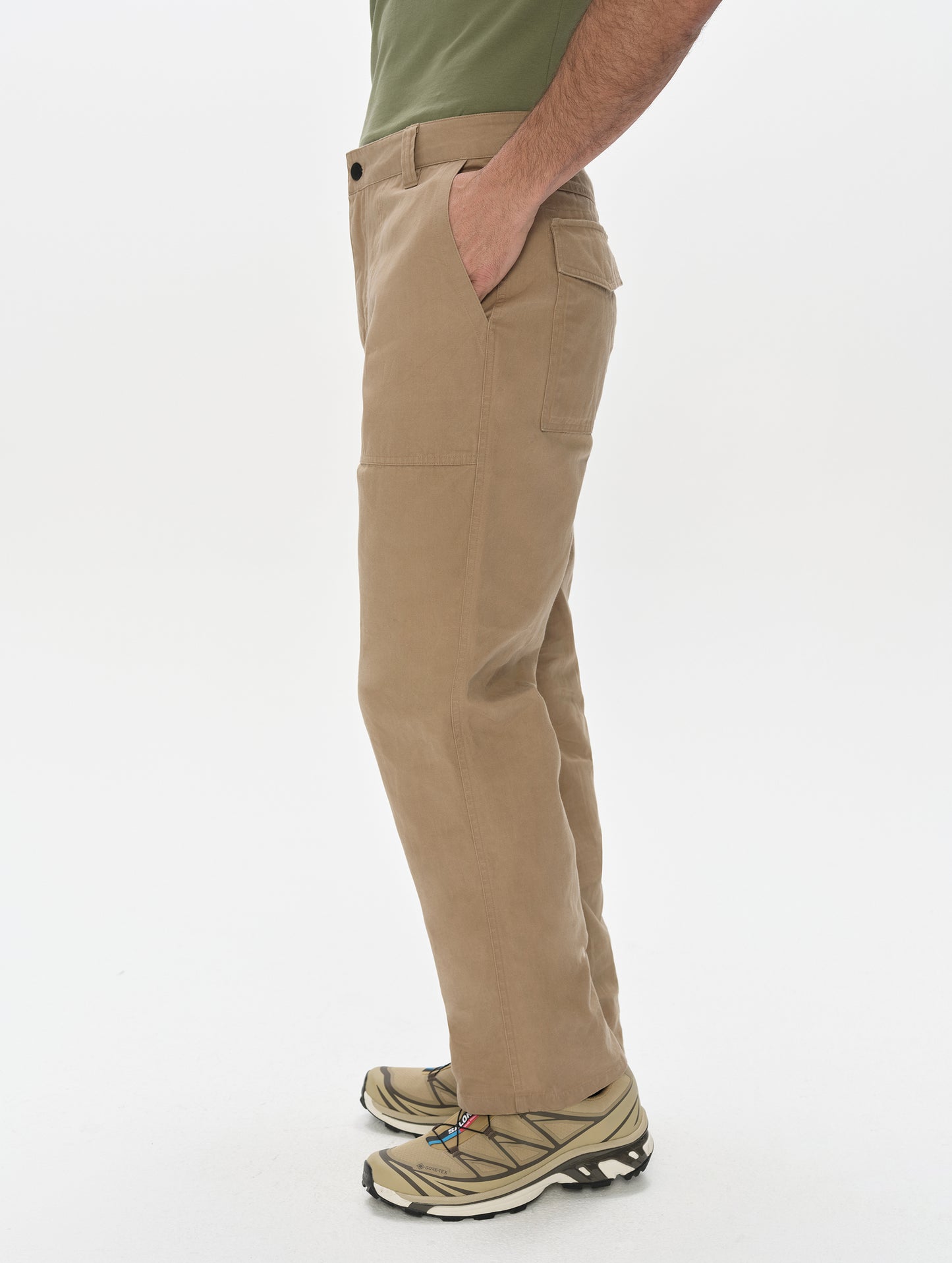 Side profile, lower-body view of man wearing the Gage Cotton Pant in Desert Tan from AETHER Apparel.