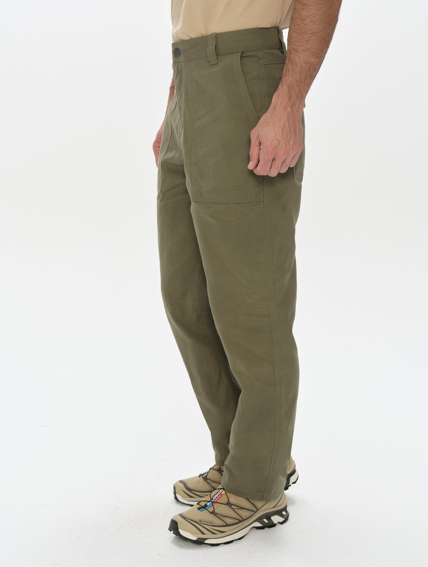 Side profile, lower-body view of man wearing the Gage Cotton Pant in Fern Green from AETHER Apparel.