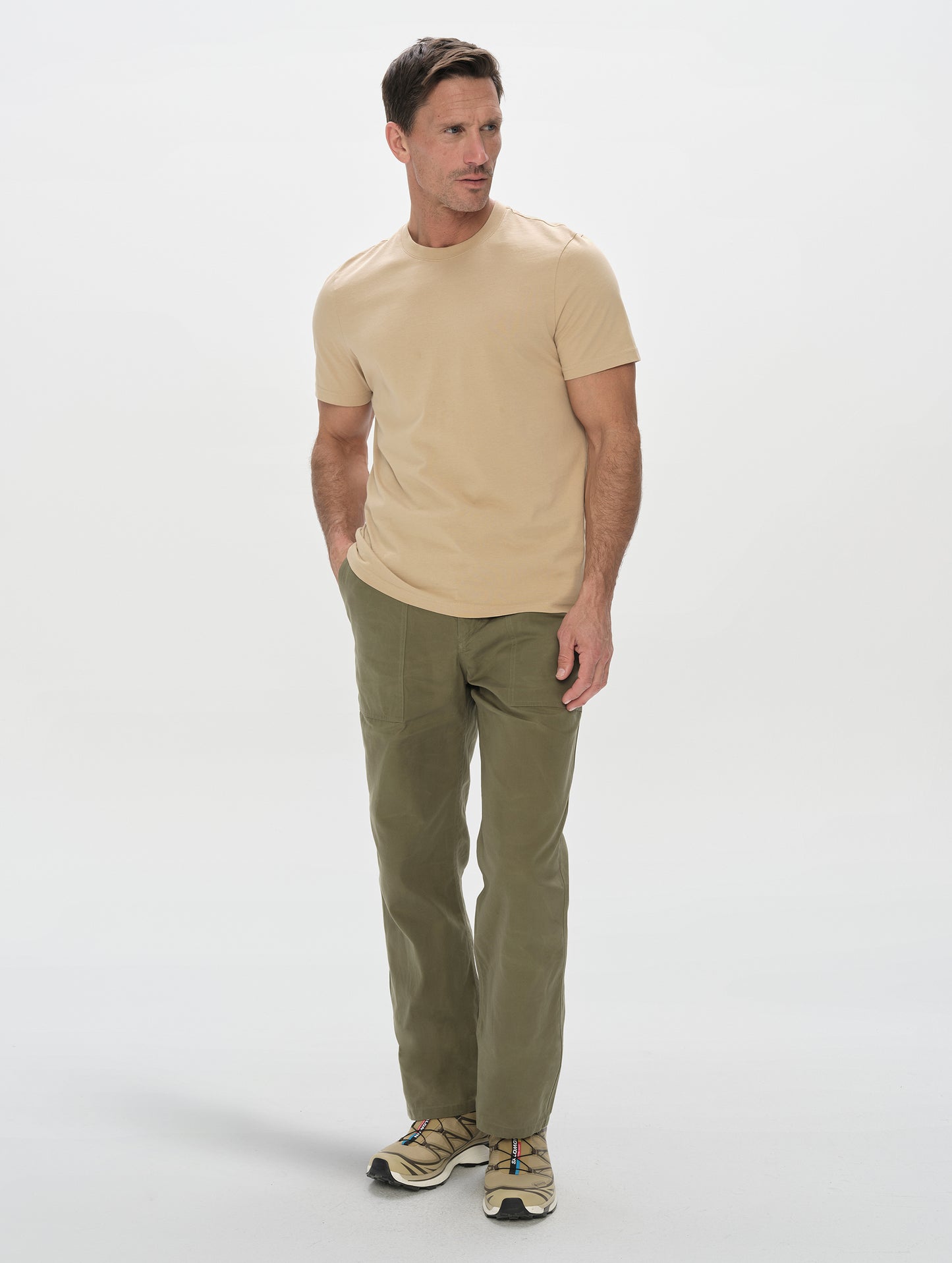 Front, full-body view of man wearing the Gage Cotton Pant in Fern Green from AETHER Apparel.