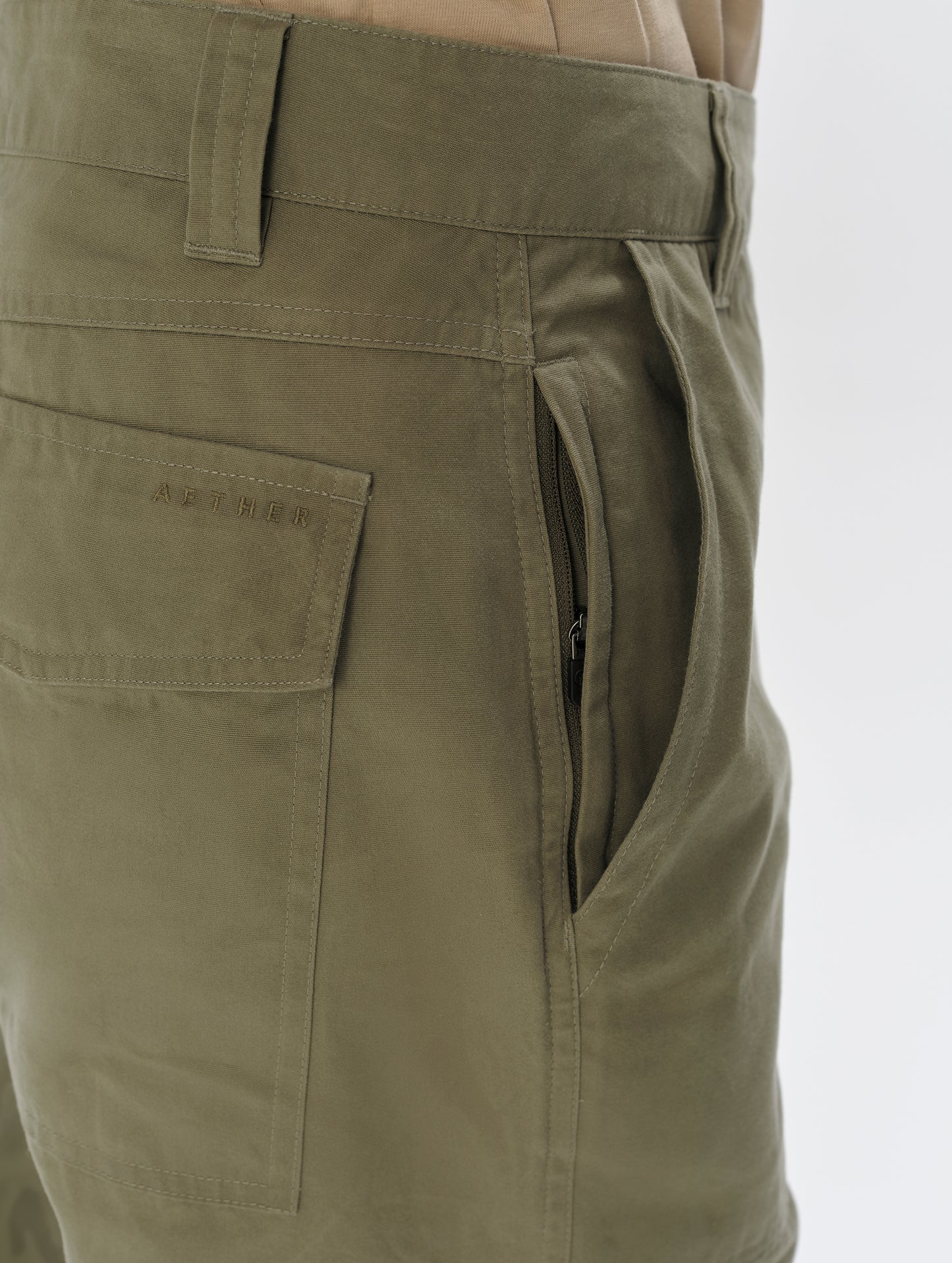 Closeup detailed view of the hand pocket and interior hand pocket on the Gage Cotton Pant in Fern Green from AETHER Apparel.