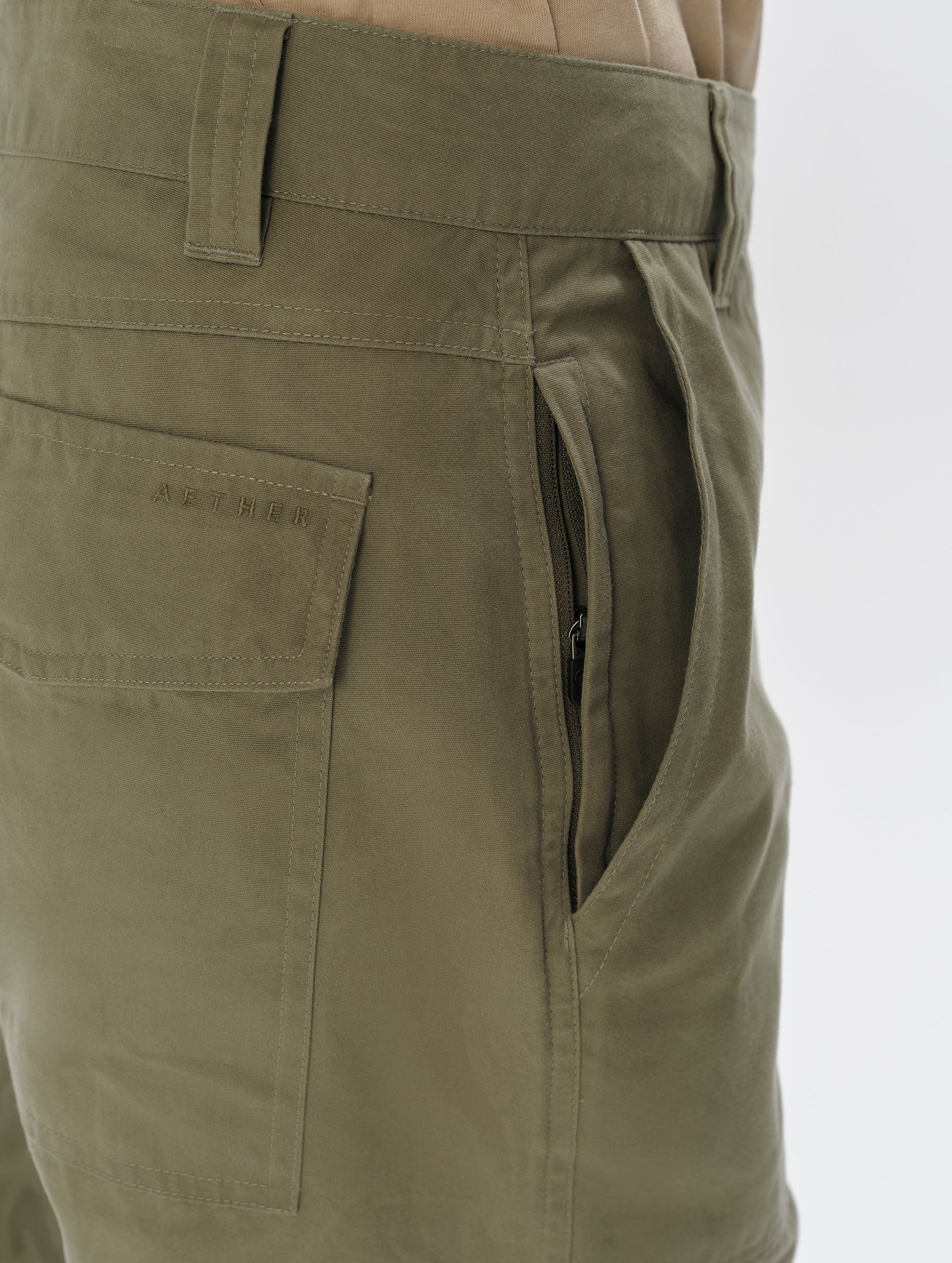 Closeup detailed view of the hand pocket and interior hand pocket on the Gage Cotton Pant in Fern Green from AETHER Apparel.