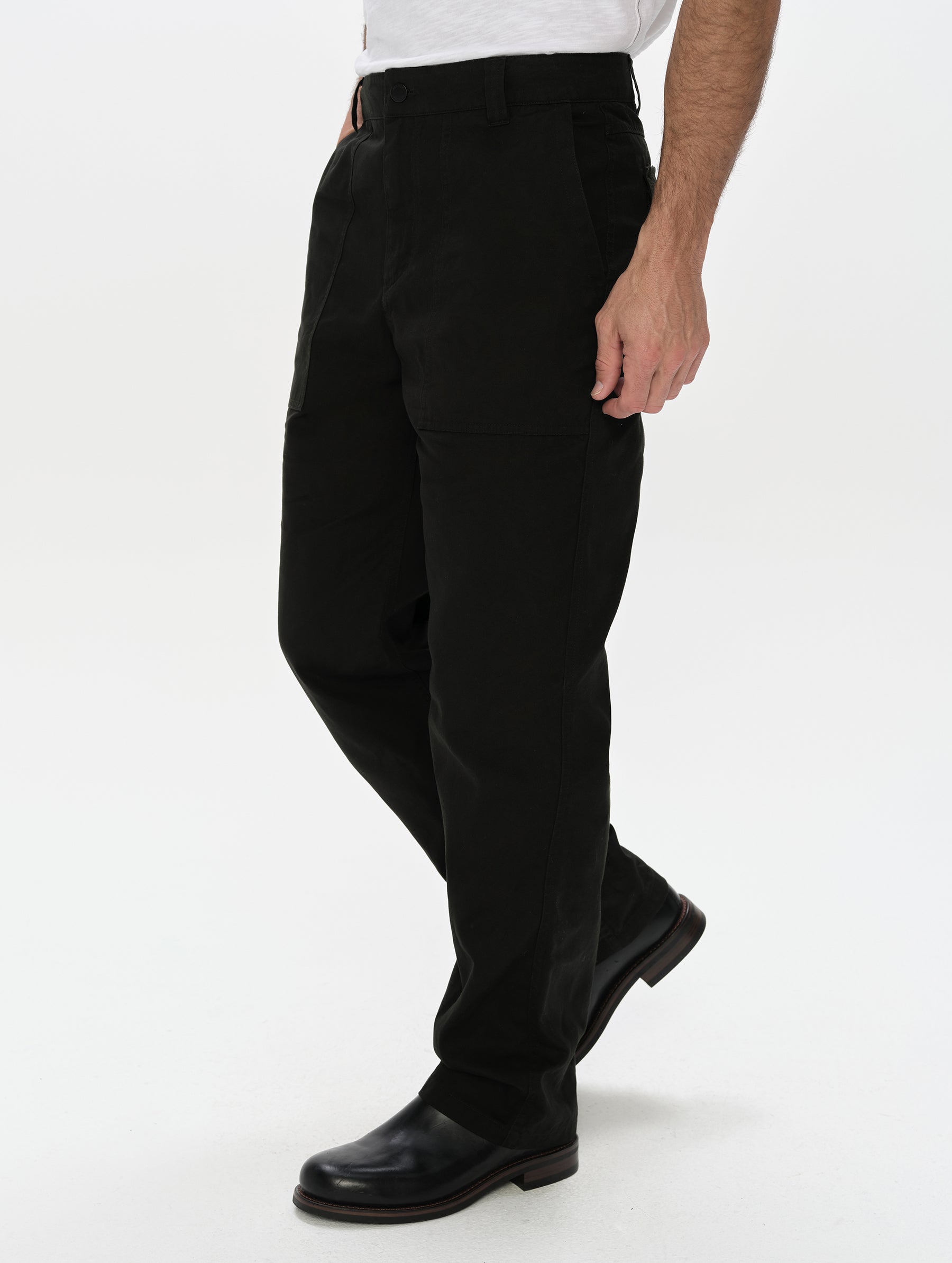 Front, 3/4, lower-body view of man wearing the Gage Cotton Pant in Onyx Black from AETHER Apparel.