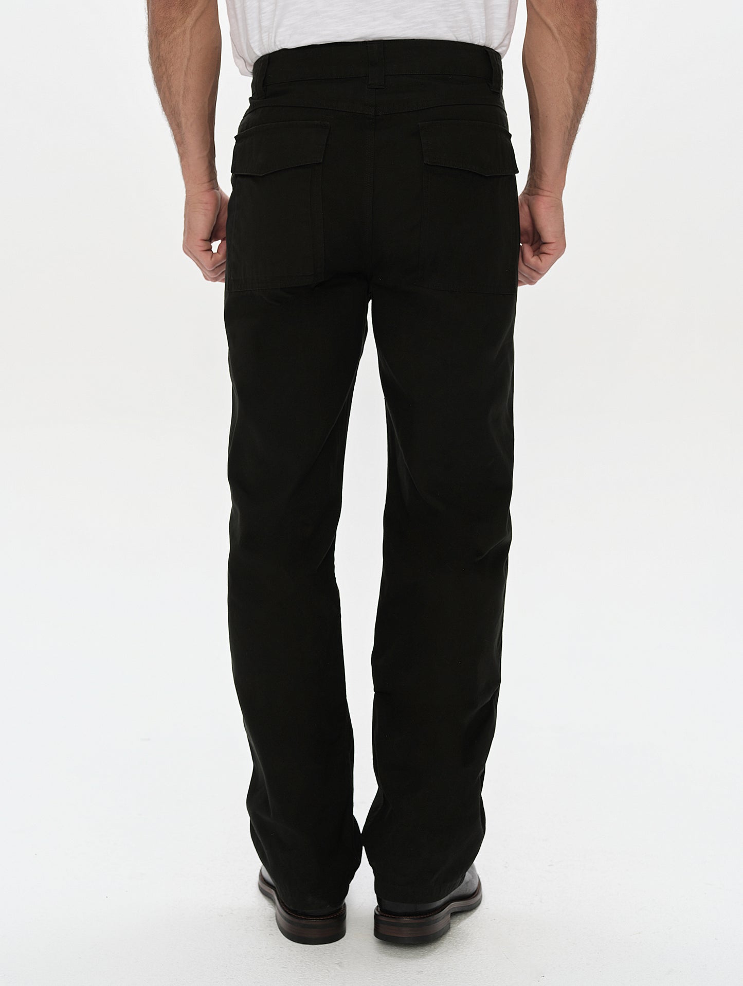 Rear, lower-body view of man wearing the Gage Cotton Pant in Onyx Black from AETHER Apparel.