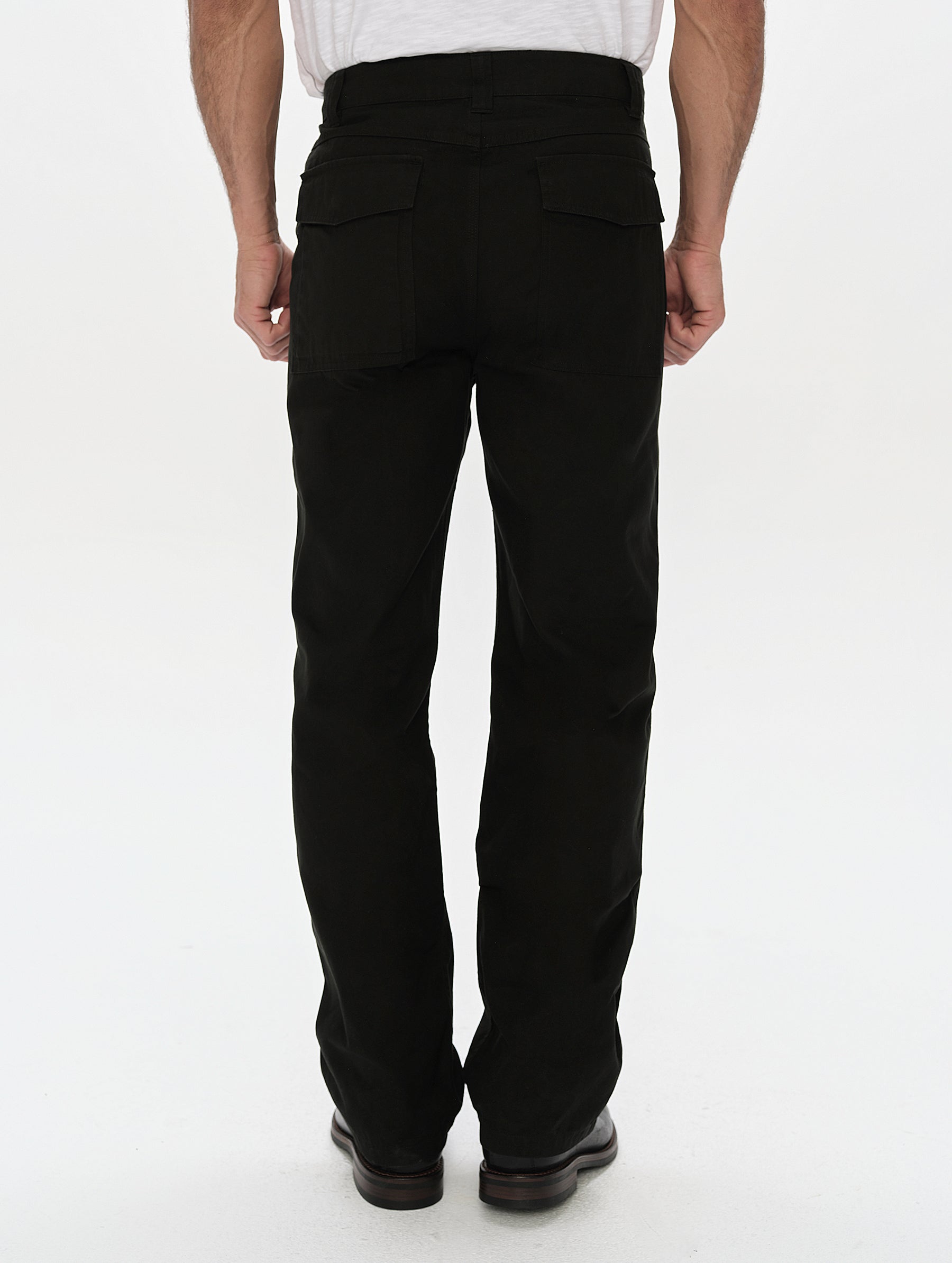 Rear, lower-body view of man wearing the Gage Cotton Pant in Onyx Black from AETHER Apparel.