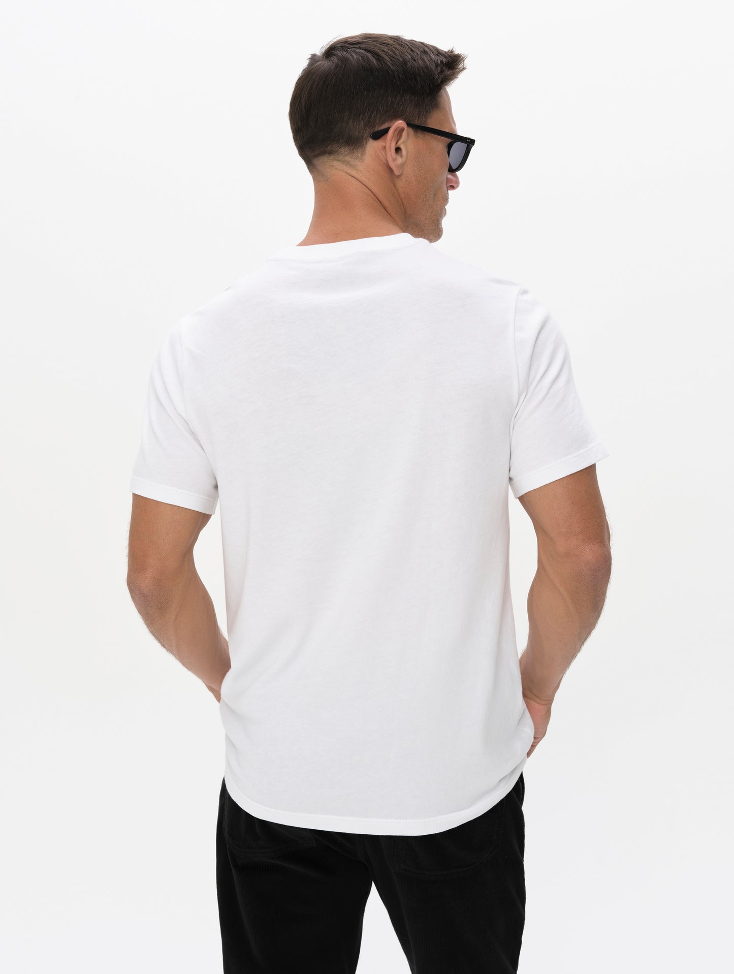 Rear upper-body view of man wearing the Graphic Tee AETHER Logo in White from AETHER Apparel.
