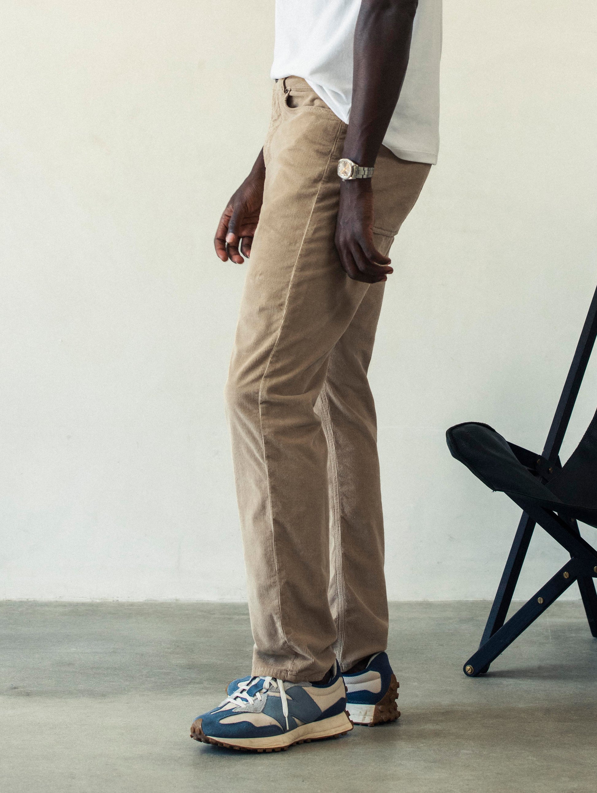 Left side profile lower body view of man wearing Hayden Corduroy Pant in Desert Tan from AETHER Apparel.