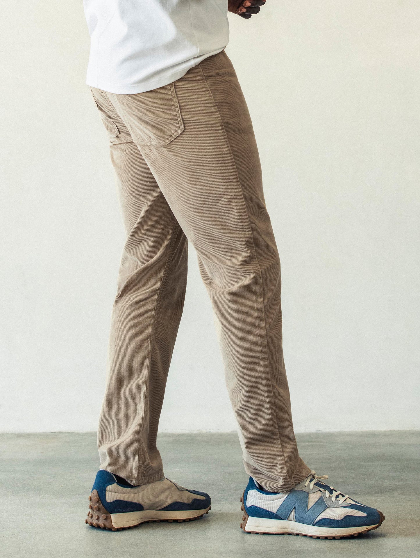 Right side profile lower body view of man wearing Hayden Corduroy Pant in Desert Tan from AETHER Apparel.