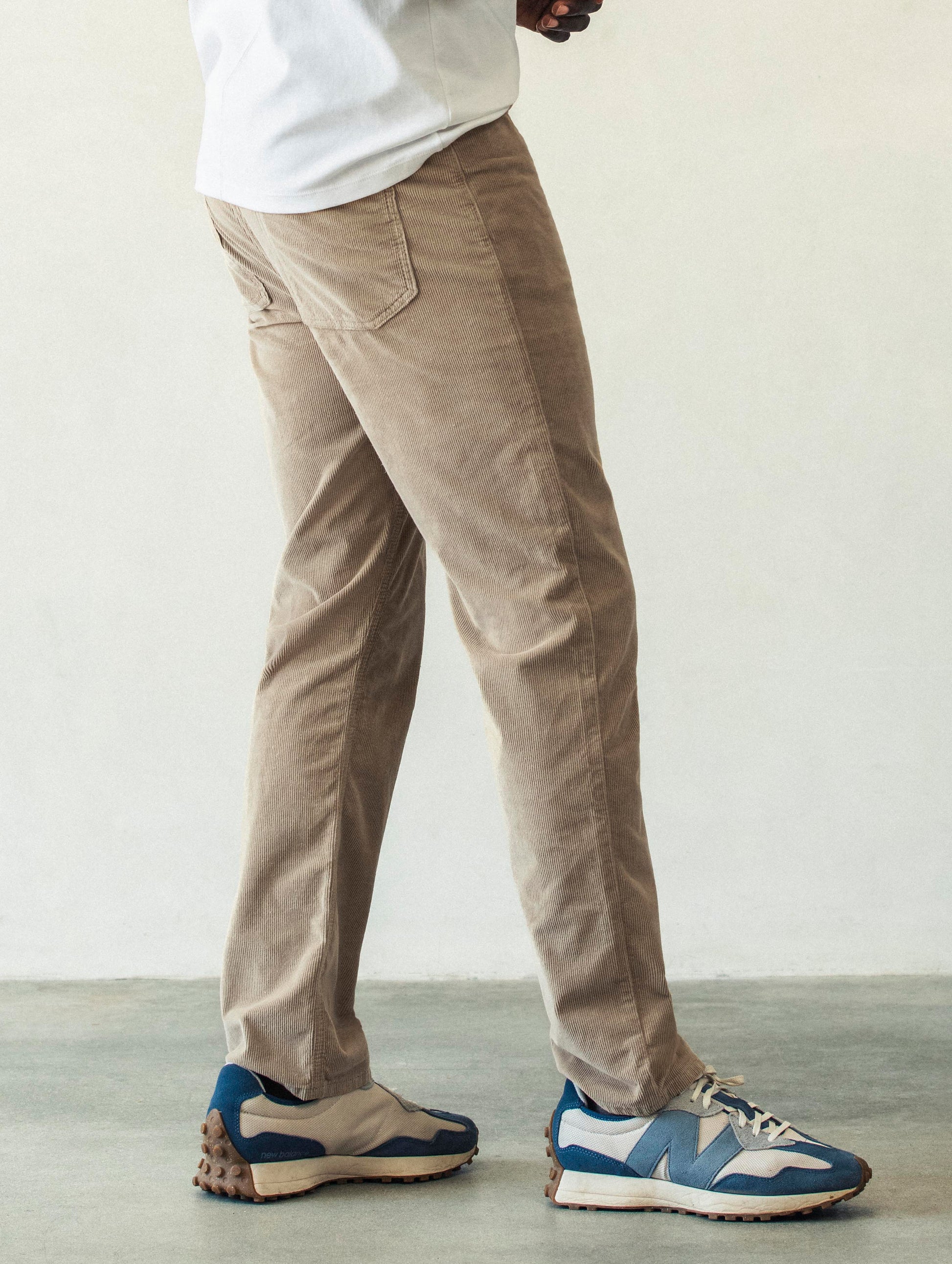 Right side profile lower body view of man wearing Hayden Corduroy Pant in Desert Tan from AETHER Apparel.