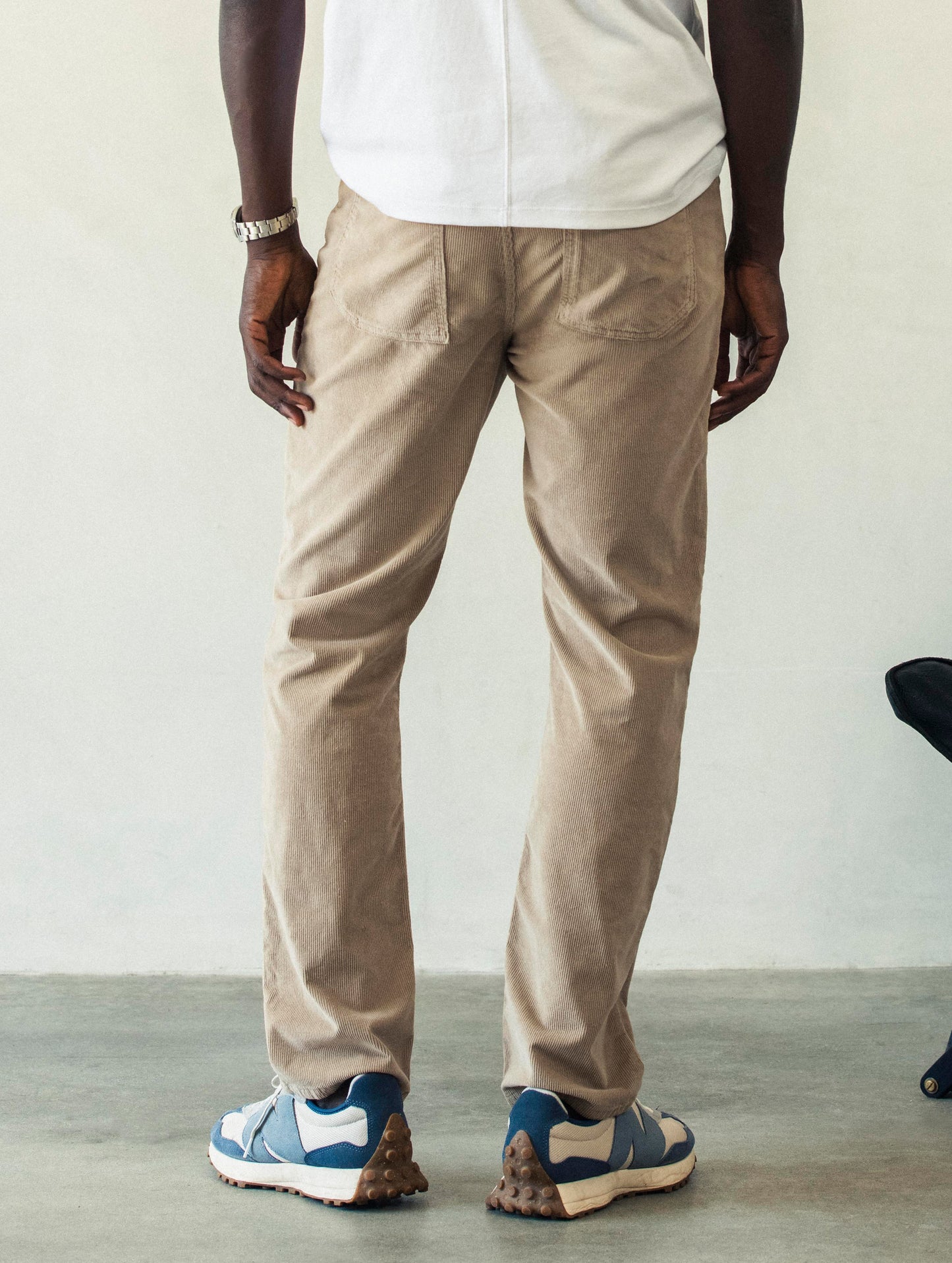 Rear lower body view of man wearing Hayden Corduroy Pant in Desert Tan from AETHER Apparel.