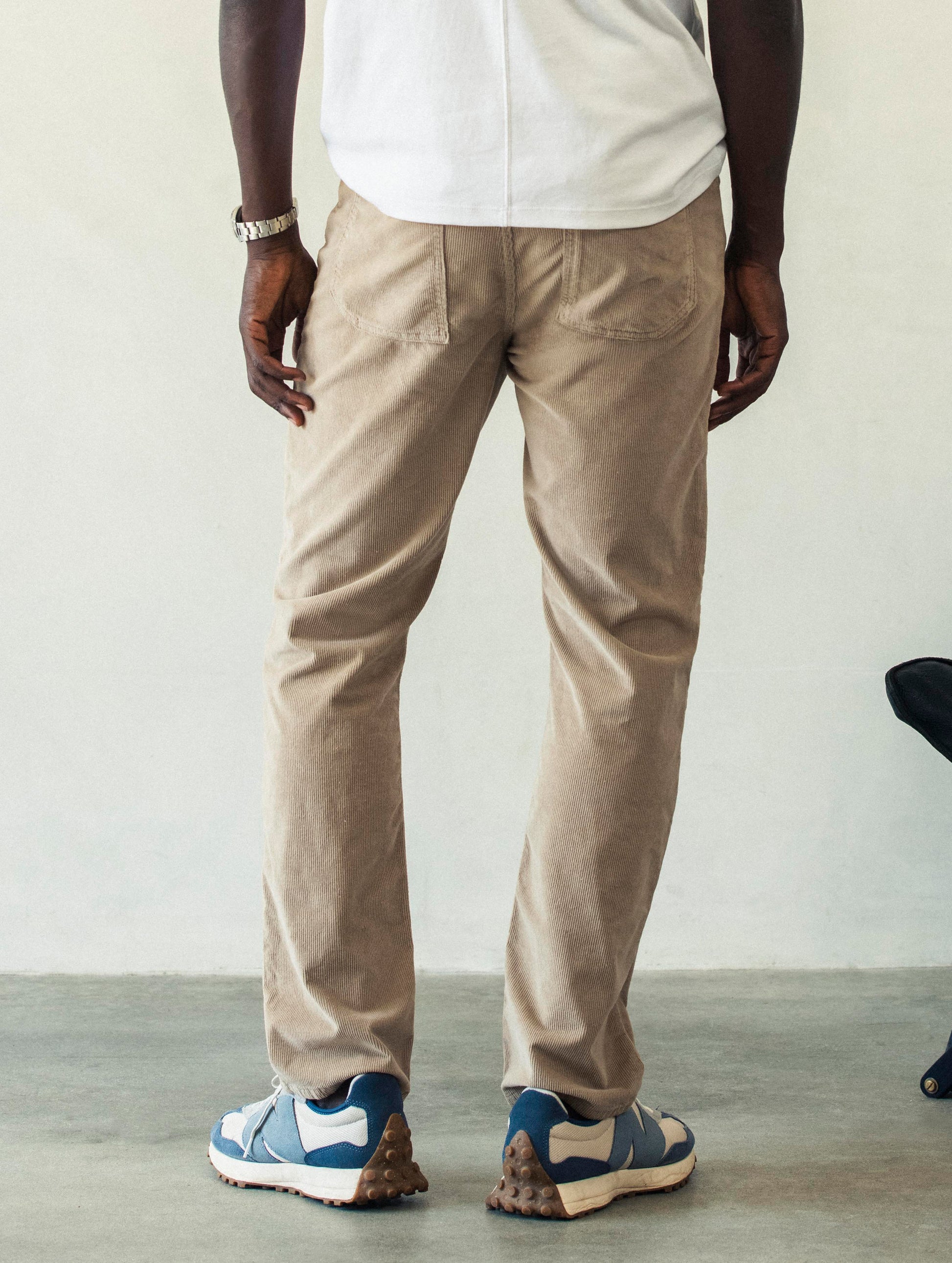 Rear lower body view of man wearing Hayden Corduroy Pant in Desert Tan from AETHER Apparel.