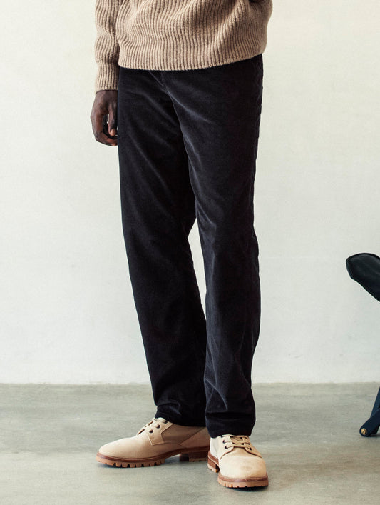 Front angled lower body view of man wearing Hayden Corduroy Pant in Tarmac Black from AETHER Apparel.