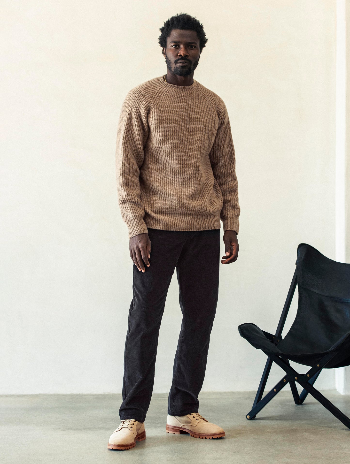 Front full-body view of man wearing Hayden Corduroy Pant in Tarmac Black from AETHER Apparel.