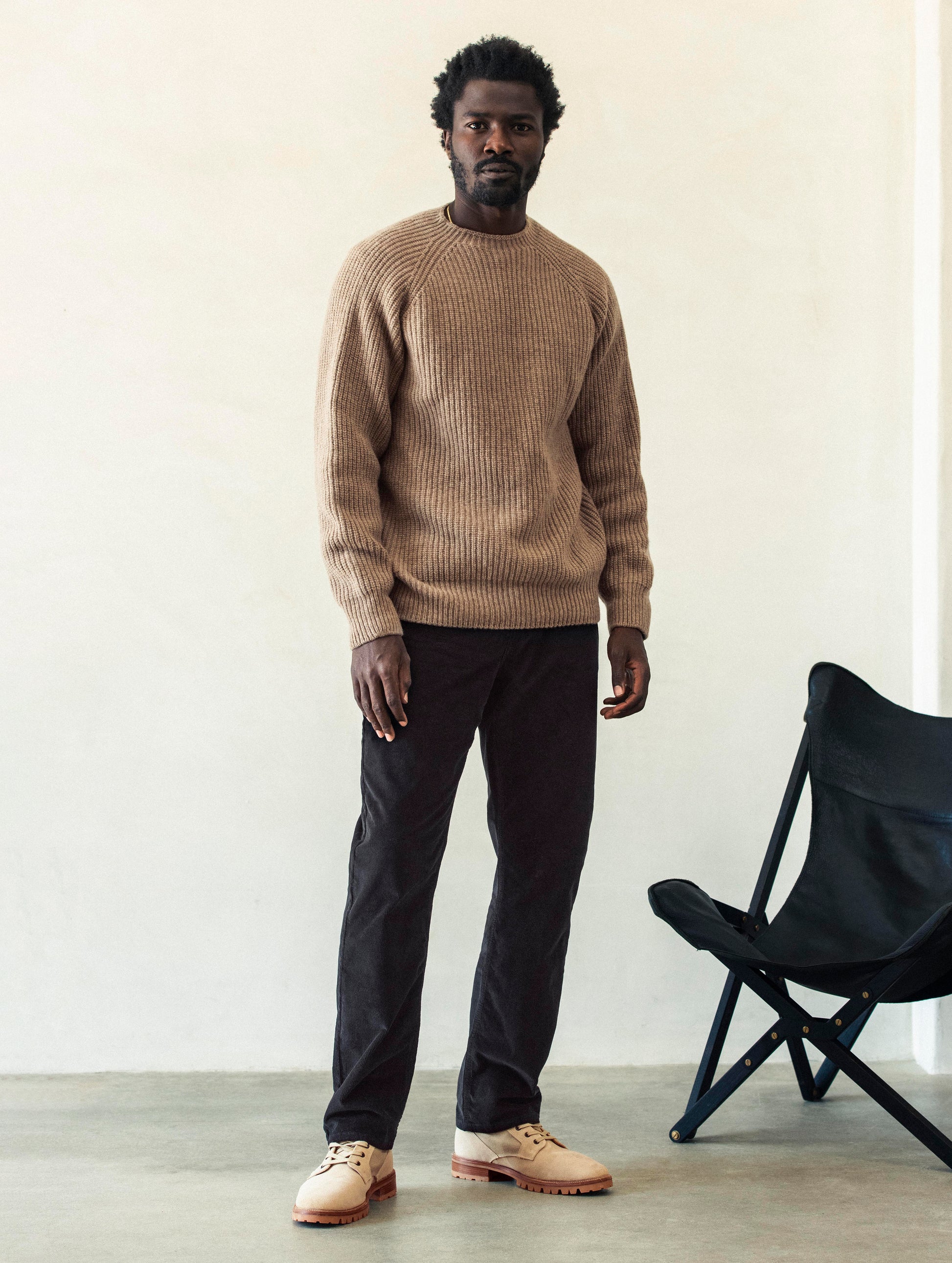 Front full-body view of man wearing Hayden Corduroy Pant in Tarmac Black from AETHER Apparel.