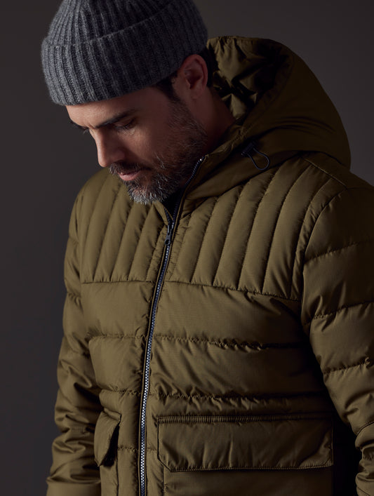 Closeup detailed view of main zipper, pockets, and baffling on Hudson Down Jacket in Command Green from AETHER Apparel.