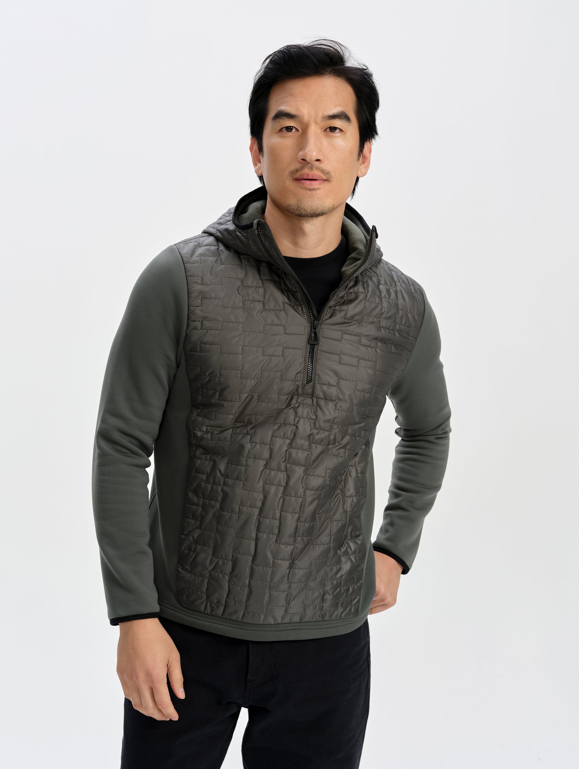 Front upper-body view of man wearing the Hybrid Tech Anorak in Saville Green from AETHER Apparel. 