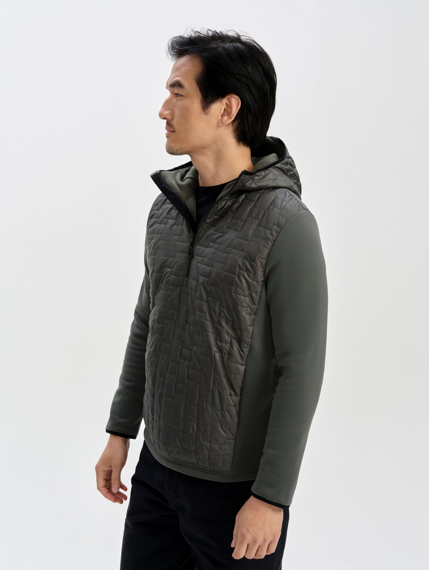 Front 3/4 upper-body view of man wearing the Hybrid Tech Anorak in Saville Green from AETHER Apparel. 