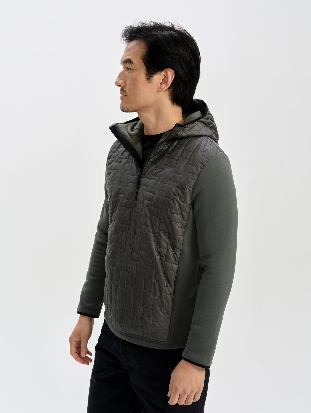 Front 3/4 upper-body view of man wearing the Hybrid Tech Anorak in Saville Green from AETHER Apparel. 