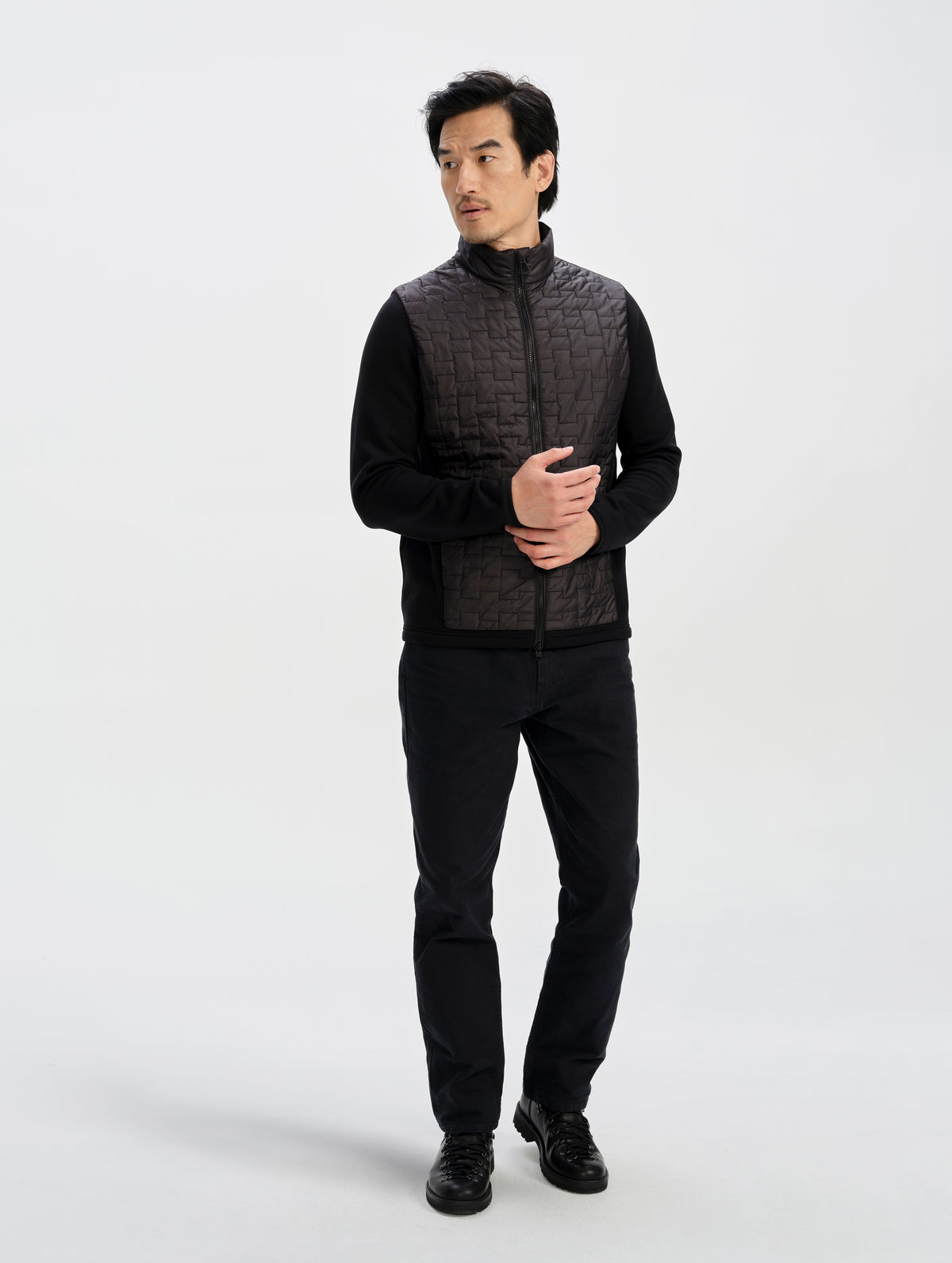 Front full-body view of man wearing the Hybrid Tech Full-Zip 2.0 in Onyx Black from AETHER Apparel. 