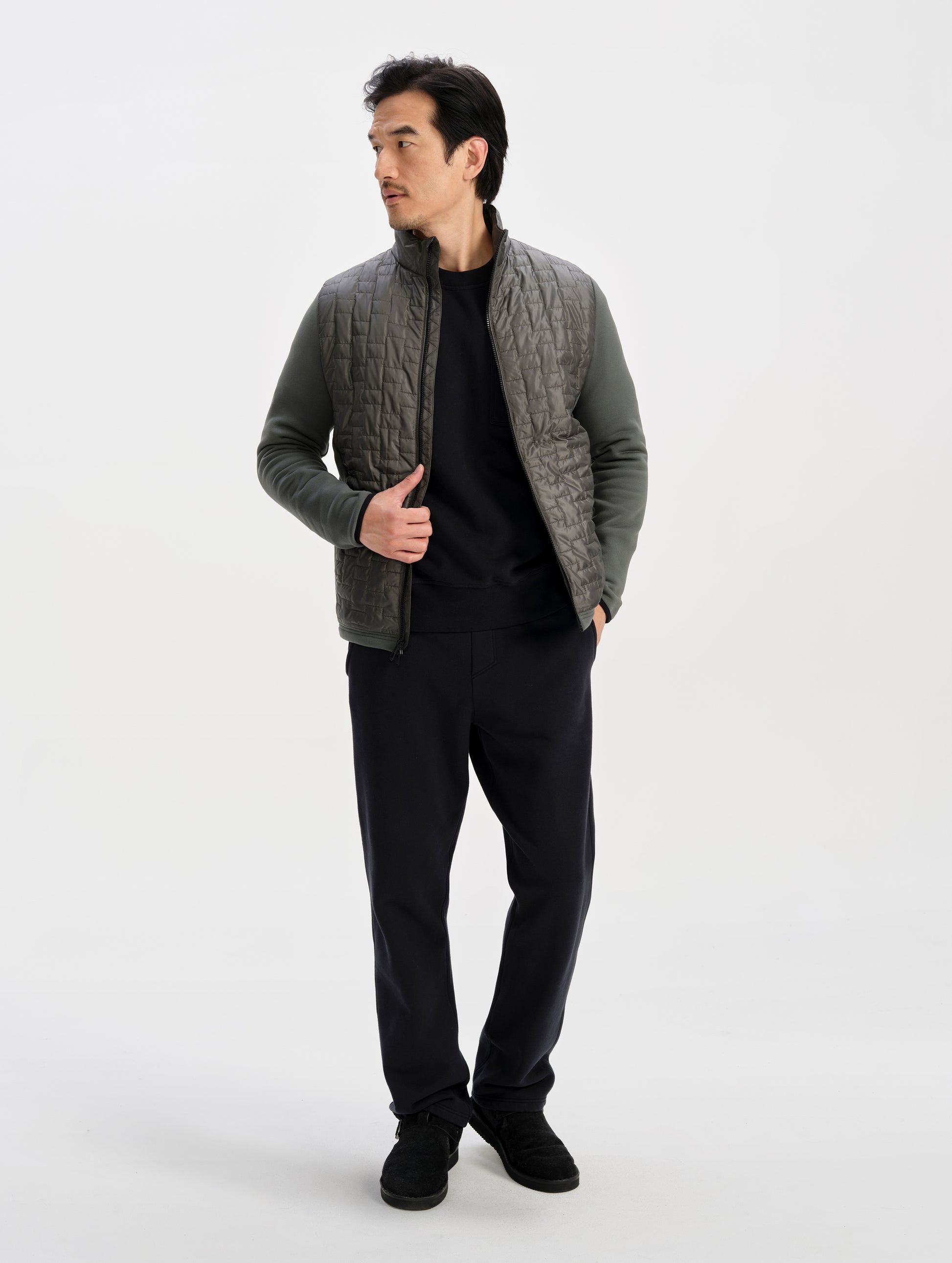 Front full-body view of man wearing the Hybrid Tech Full-Zip 2.0 in Saville Green from AETHER Apparel. 