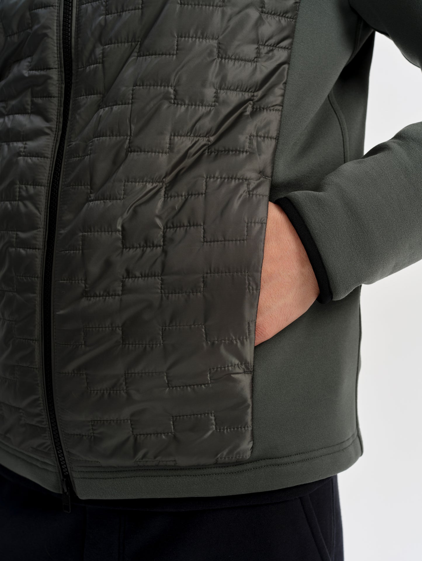 Closeup detailed view of the zippered hand pocket on the Hybrid Tech Full-Zip 2.0 in Saville Green from AETHER Apparel. 