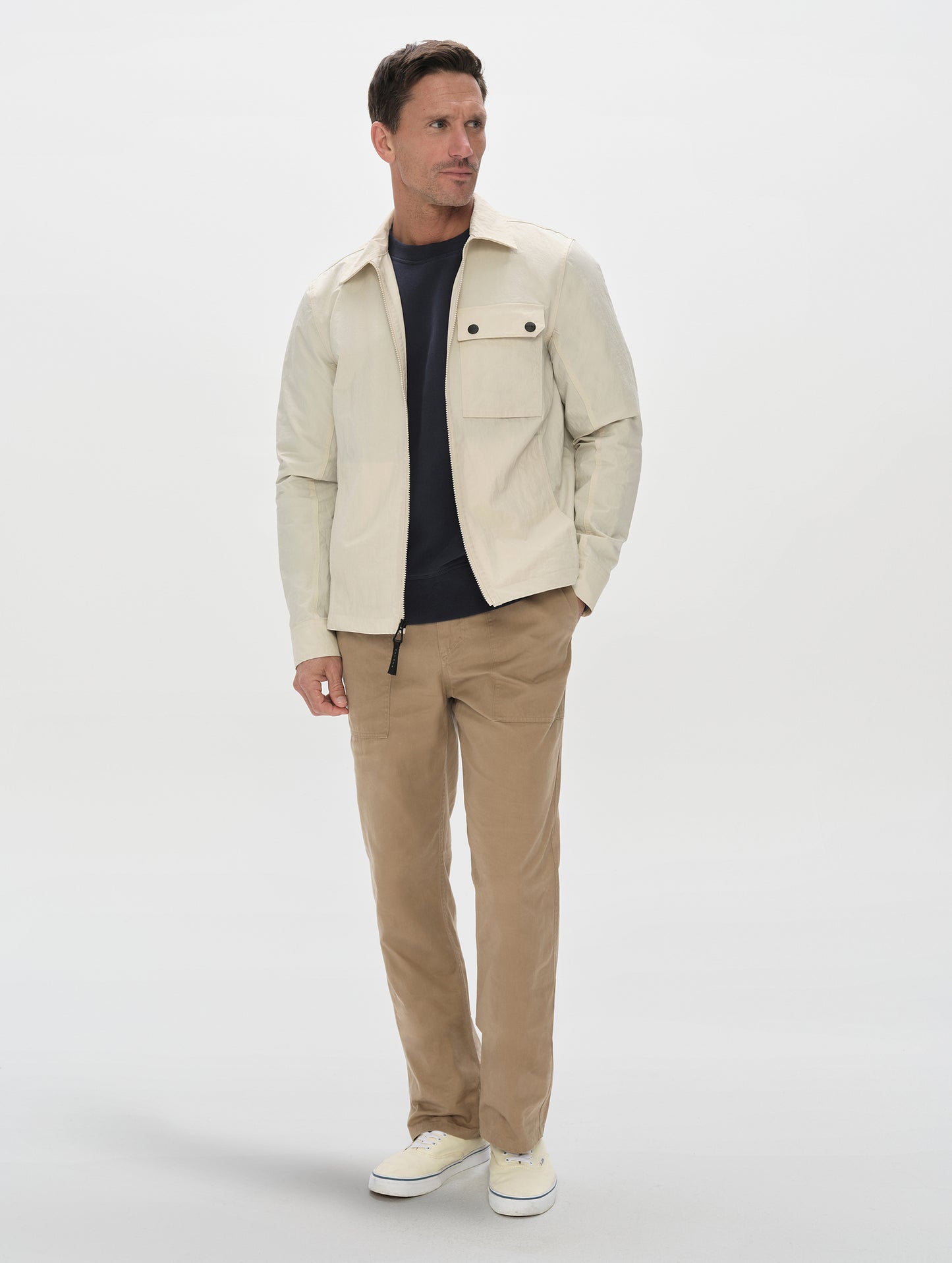 Front, full-body view of man wearing the Landon Jacket in Onyx Black from AETHER Apparel.