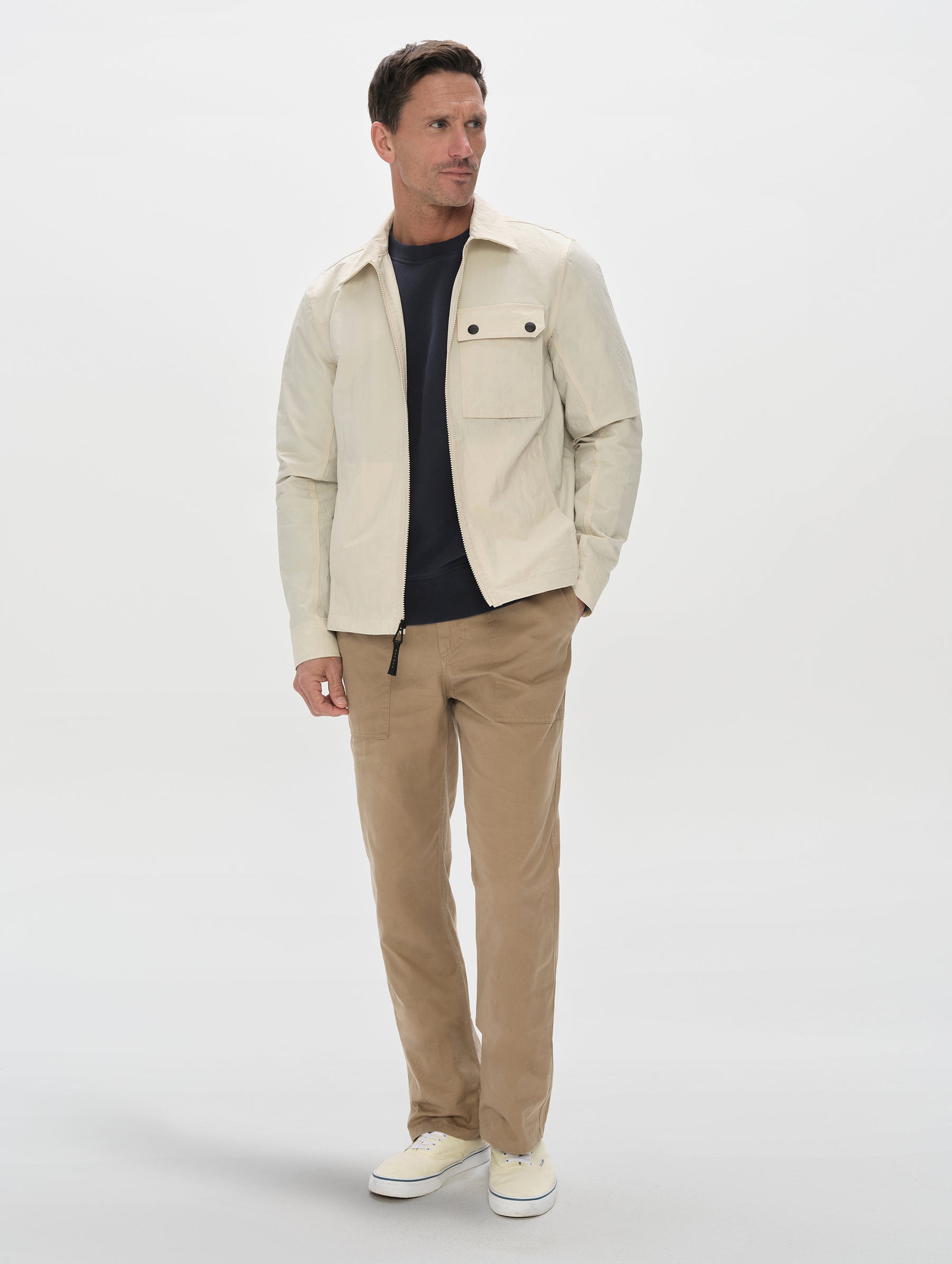 Front, full-body view of man wearing the Landon Jacket in Onyx Black from AETHER Apparel.