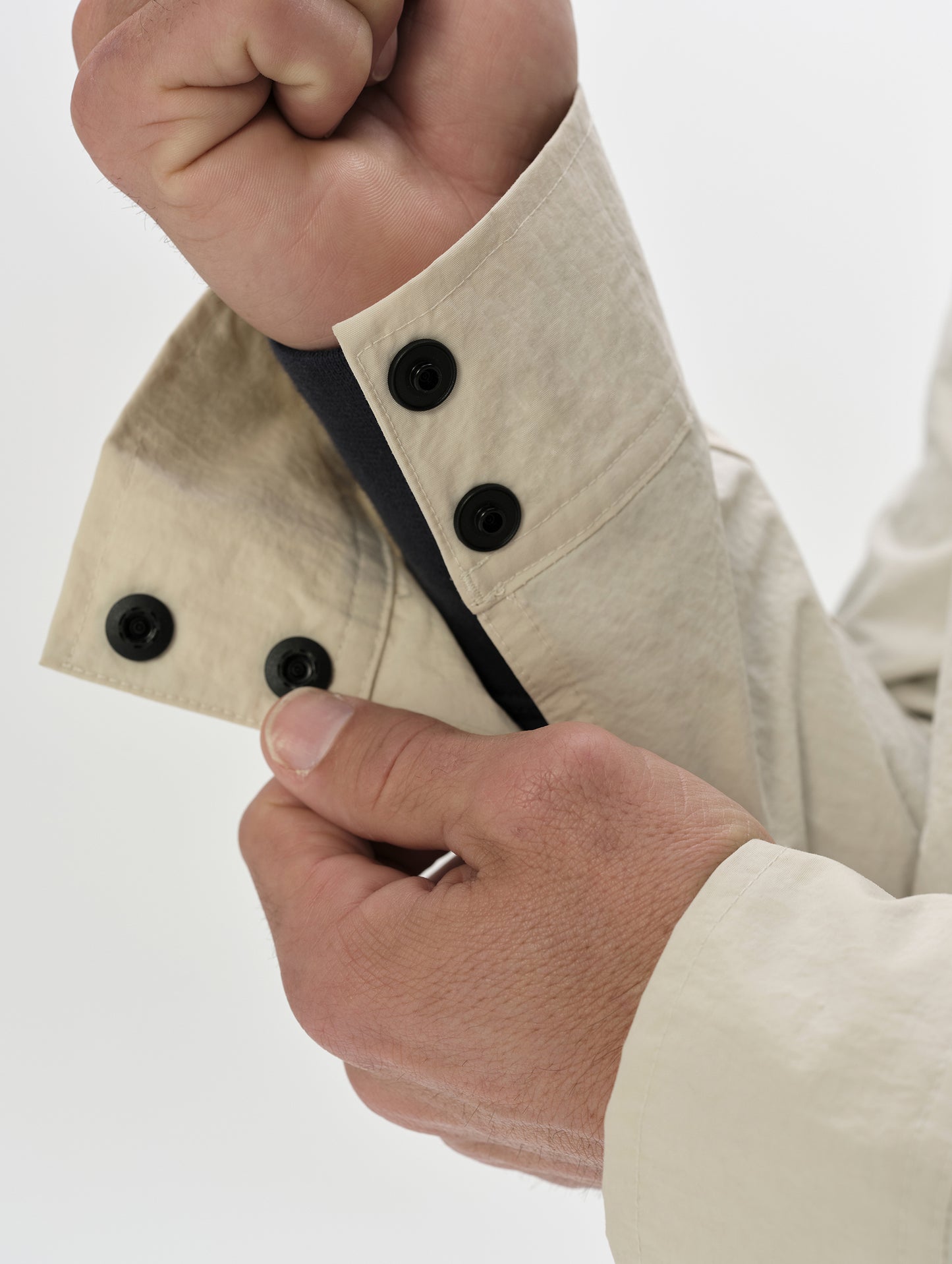 Closeup detailed view of the dual-button sleeve cuffs on the Landon Jacket in Bone from AETHER Apparel.