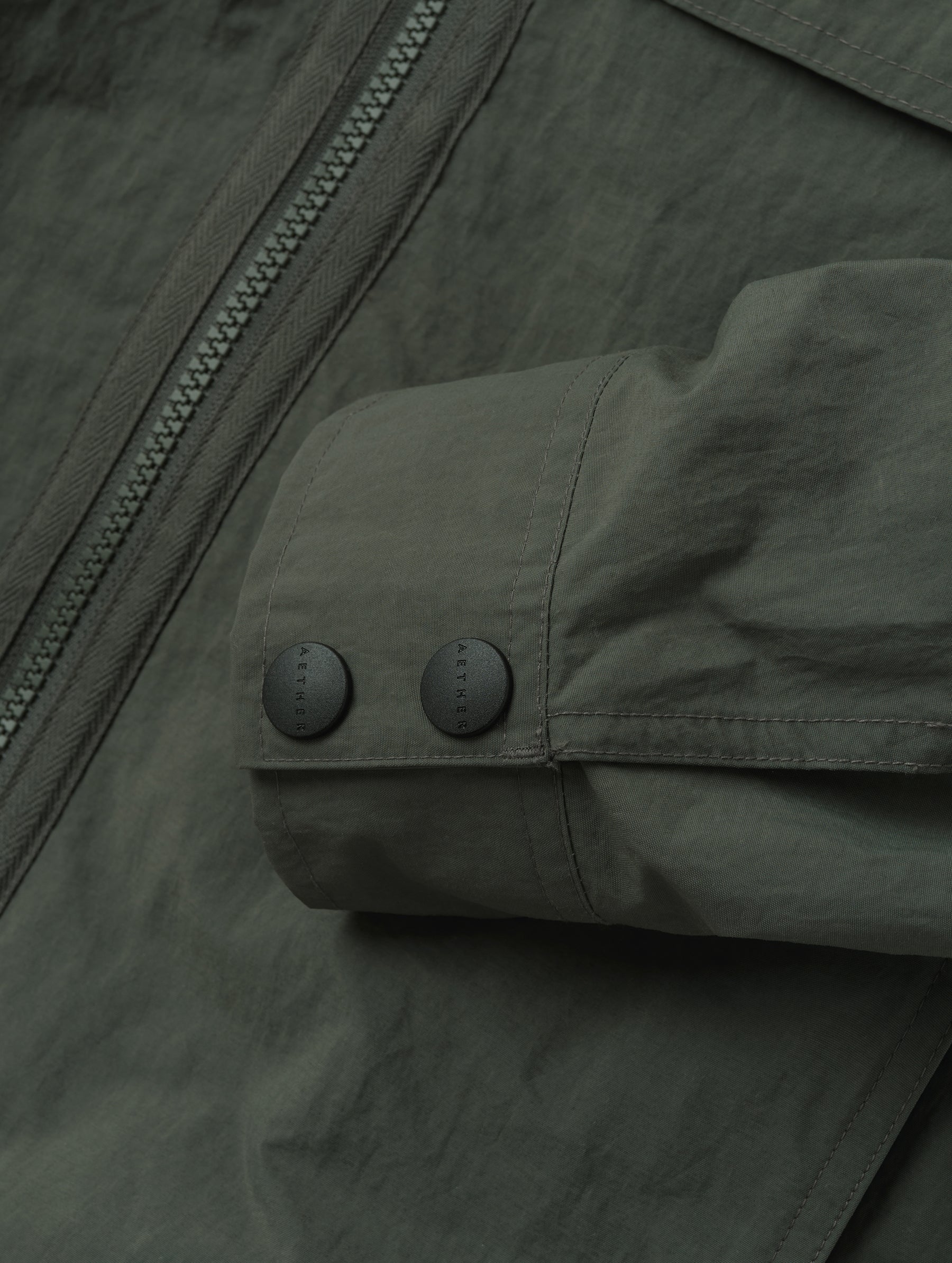 Closeup detailed view of the dual-button sleeve cuffs on the Landon Jacket in Saville Green from AETHER Apparel.