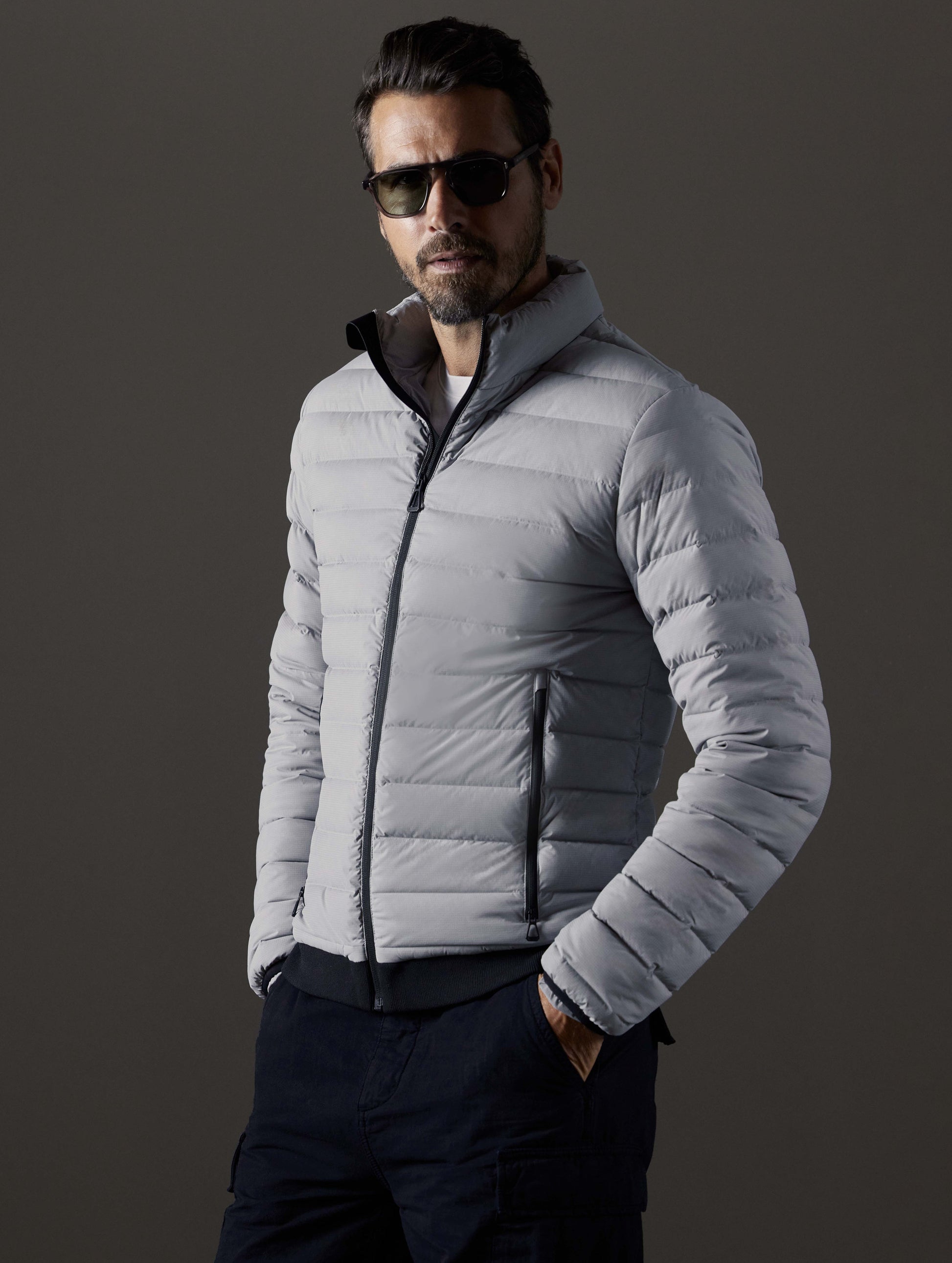 Front 3/4 body view of man wearing Launch Full-Zip Jacket NH in Sky Grey from AETHER Apparel.