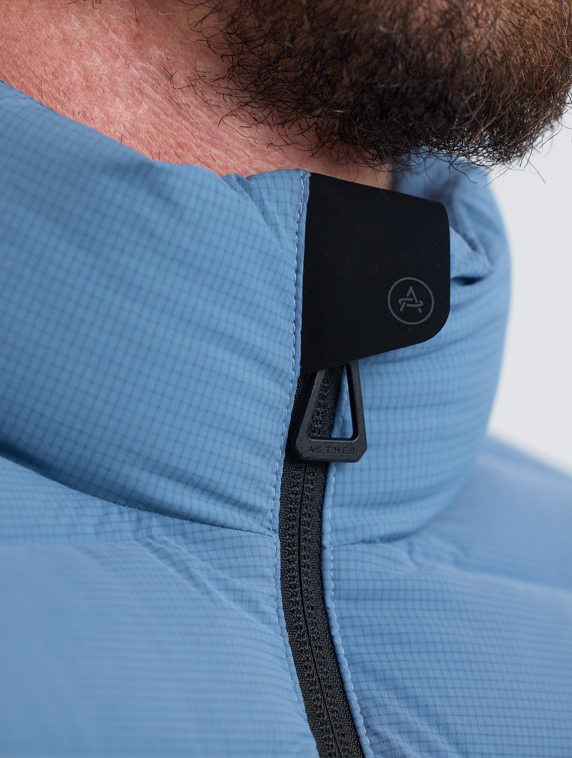 Closeup view of collar of Prospect Packable Down Jacket in Portal Blue from AETHER Apparel.
