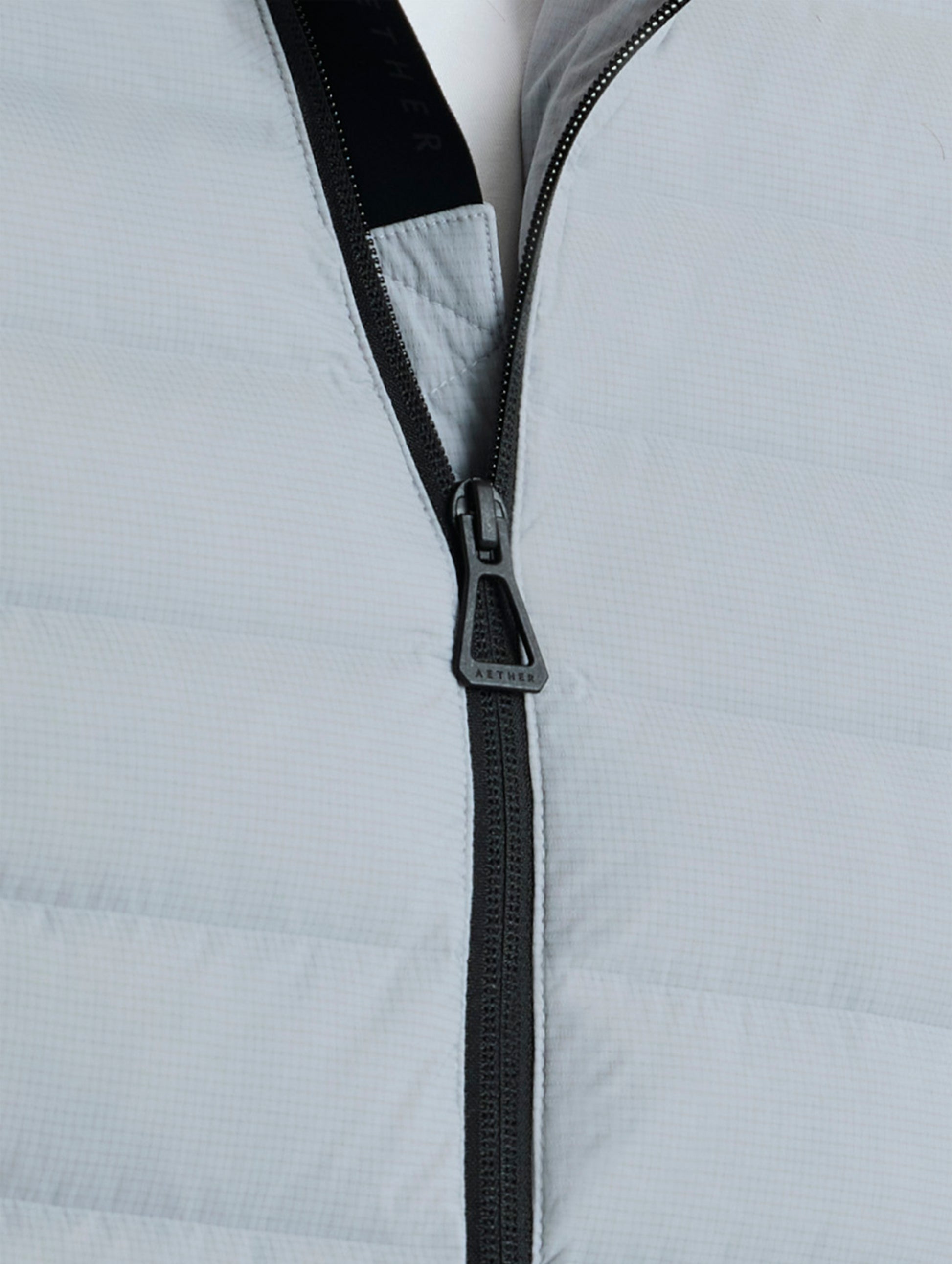 Closeup view of center zipper of Launch Jacket in Sky Grey from AETHER Apparel.